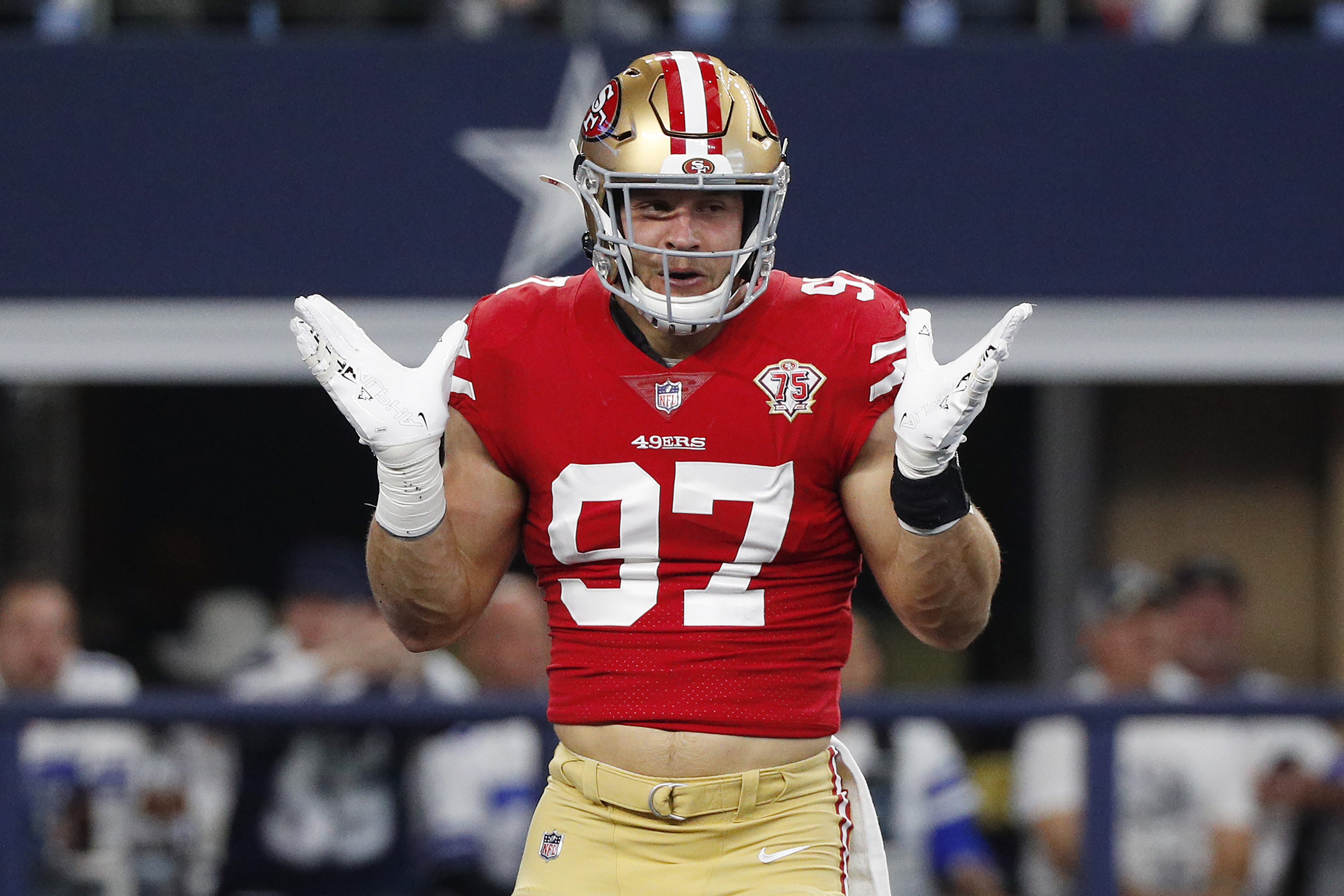 Nick Bosa #97 of the San Francisco 49ers reacts after a sack against the Dallas Cowboys during the first quarter in the NFC Wild Card Playoff game at AT&amp;T Stadium on January 16, 2022 in Arlington, Texas.
