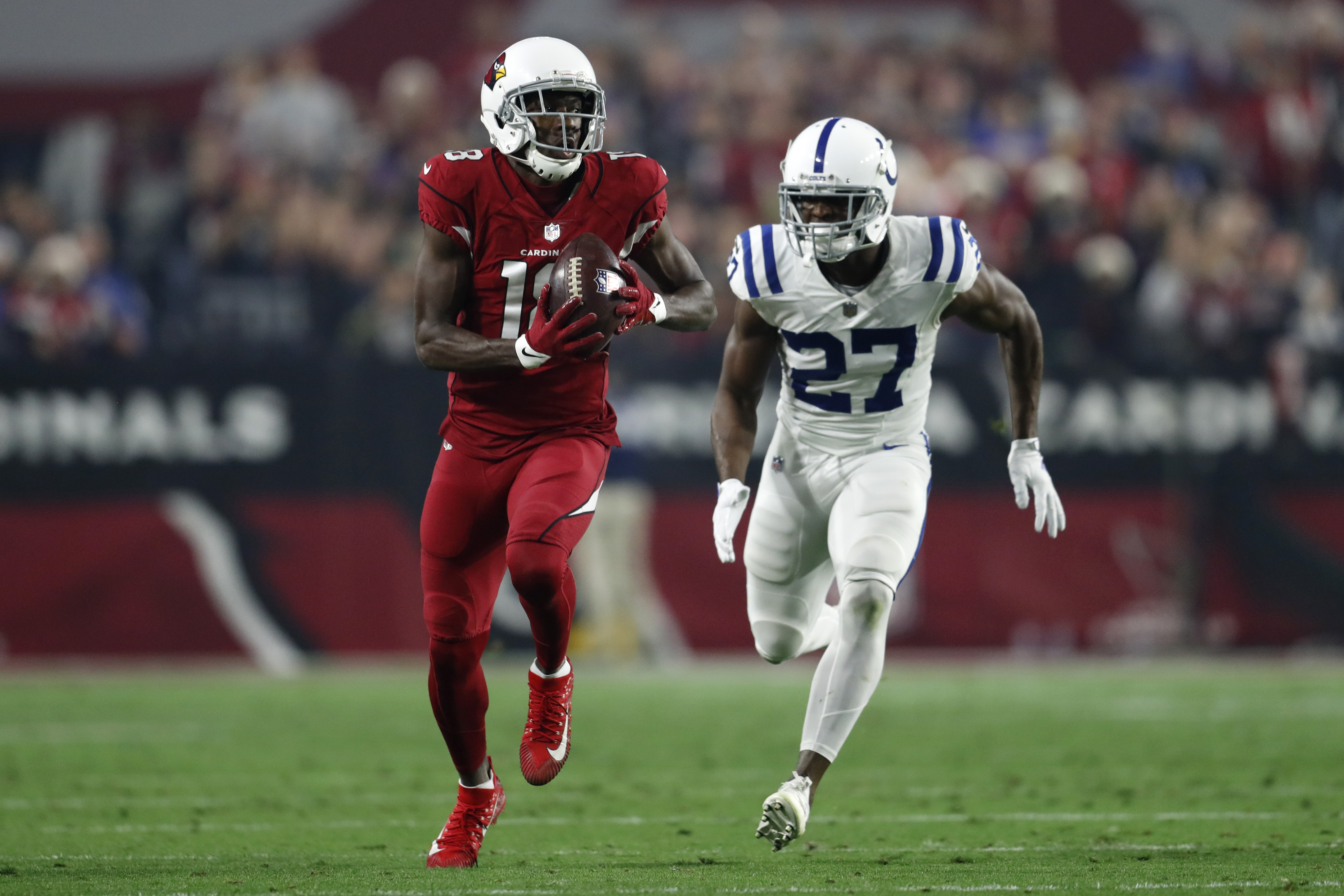 Cornerback Xavier Rhodes #27 of the Indianapolis Colts attempts to tackle wide receiver A.J. Green #18 of the Arizona Cardinals during the second half of the game at State Farm Stadium on December 25, 2021 in Glendale, Arizona. The Colts beat the Cardinals 22-16.
