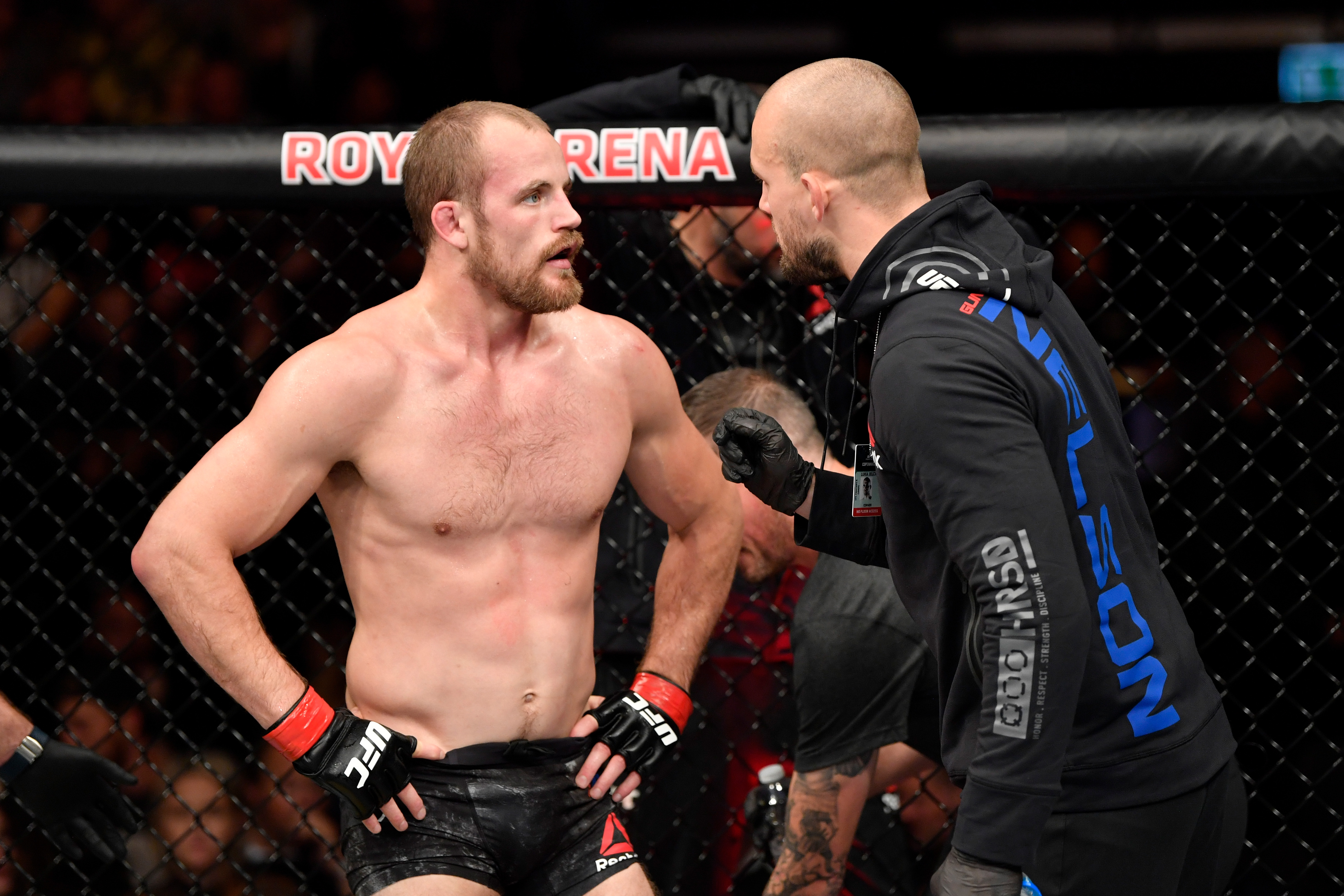Gunnar Nelson talks to his coach between rounds during his 2019 fight with Gilbert Burns.