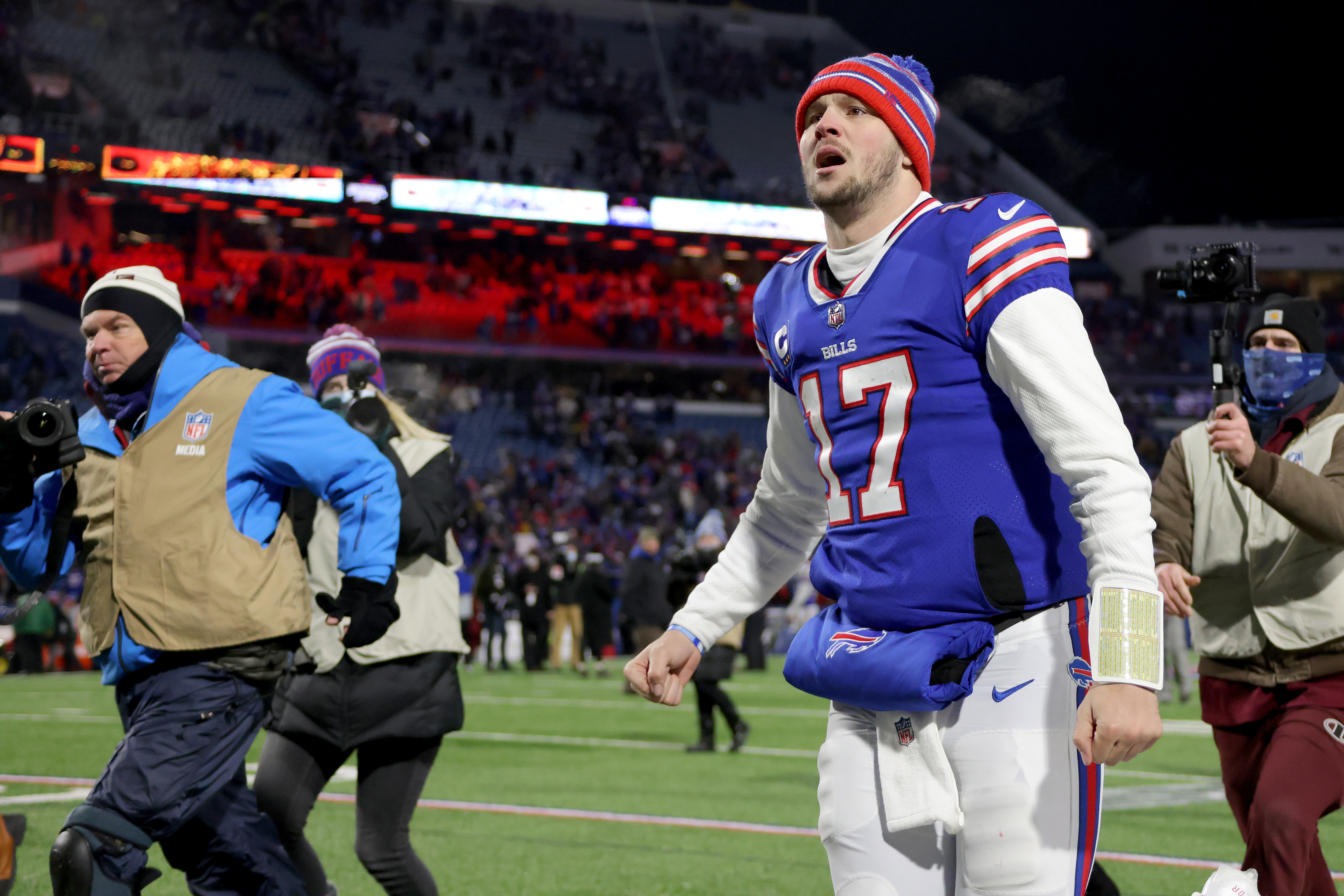 Josh Allen #17 of the Buffalo Bills walks off the field after defeating the New England Patriots with a score of 47 to 17 in the AFC Wild Card playoff game at Highmark Stadium on January 15, 2022 in Buffalo, New York.