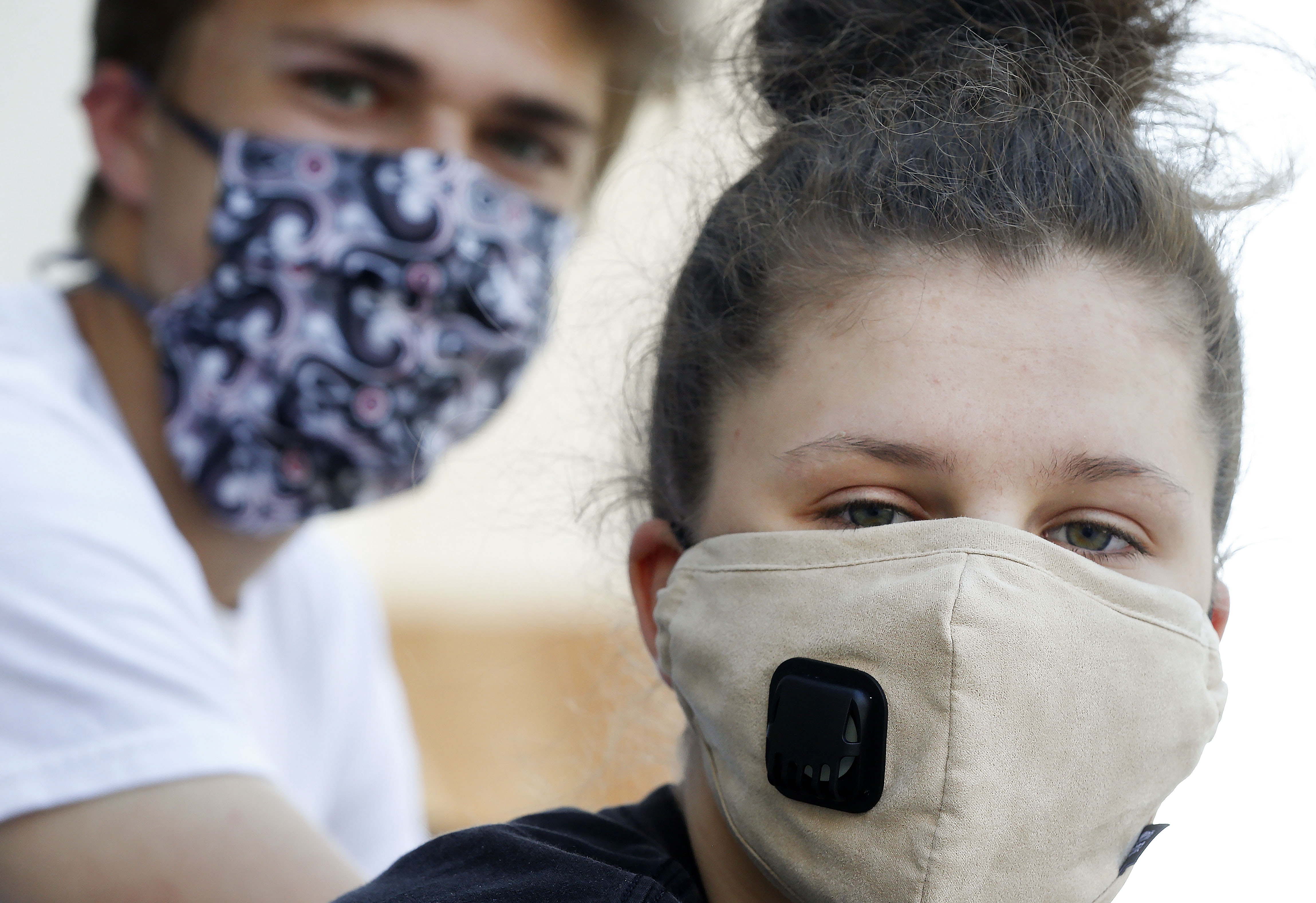 Micah Goldstein, 18, left, and his sister, Liana Pruyn Goldstein, 17, wear masks in Salt Lake City.