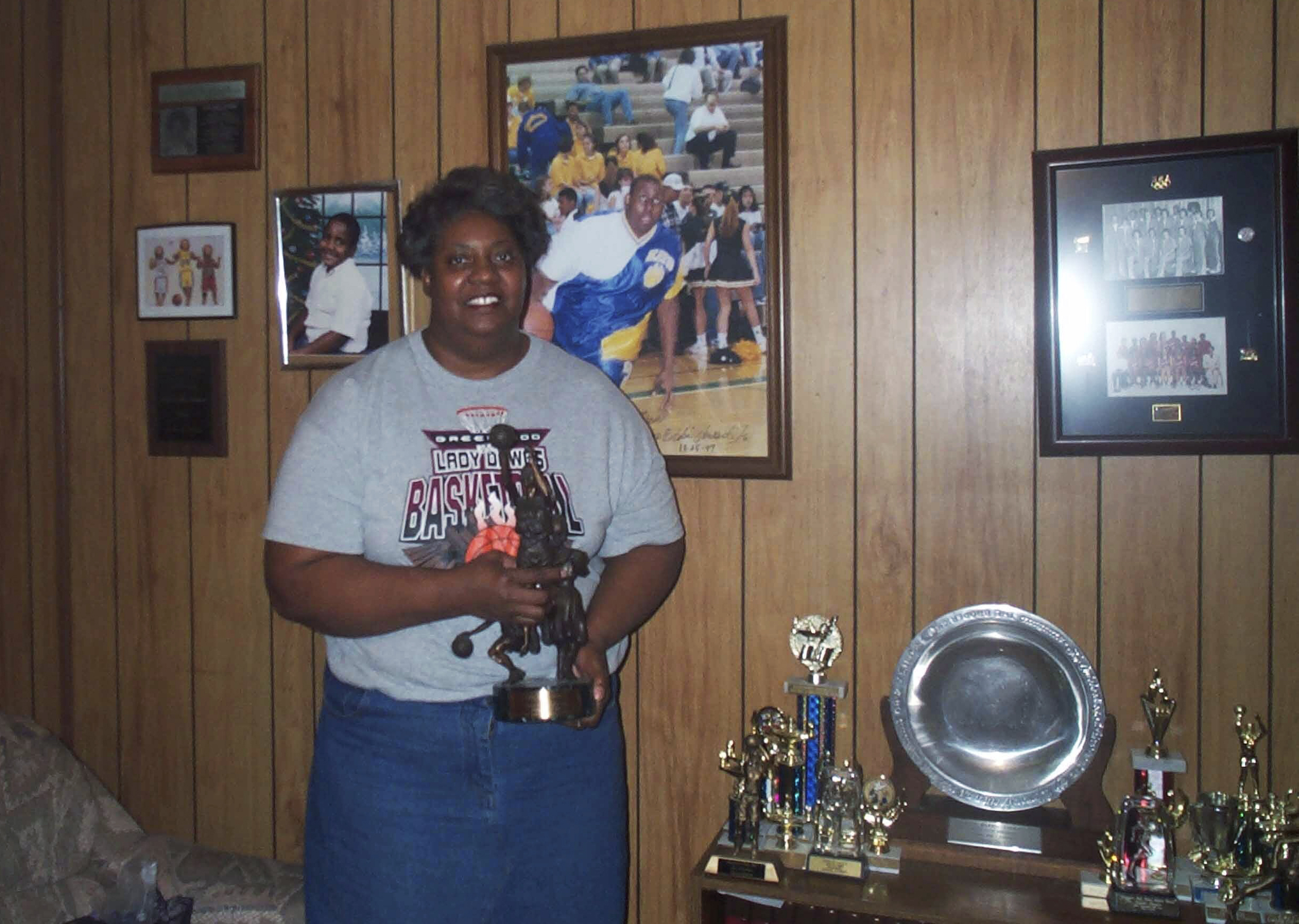 Lusia Harris shows off some of her medals and awards from her basketball career. in a 2002 file photo. Harris died Tuesday at age 66. 