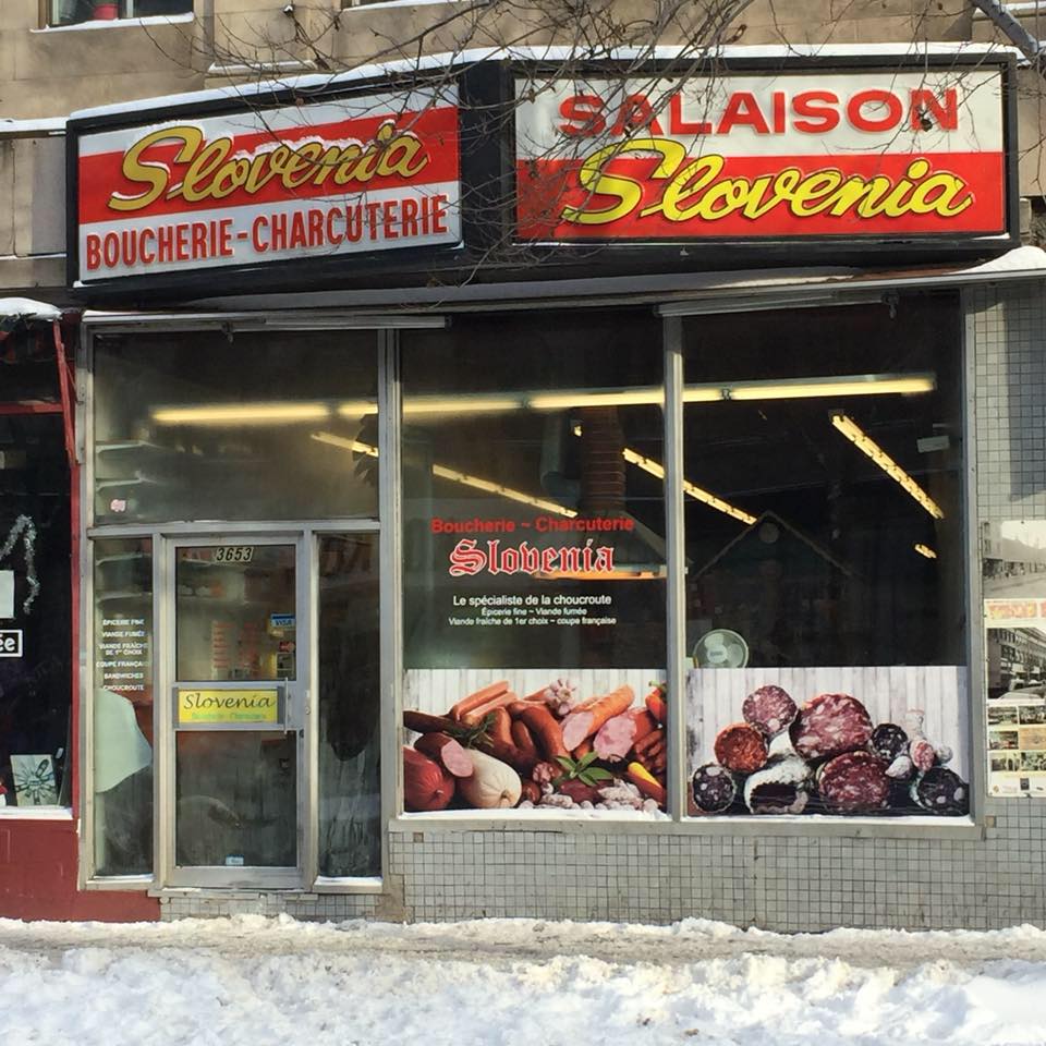 outside of butcher shop with red signage