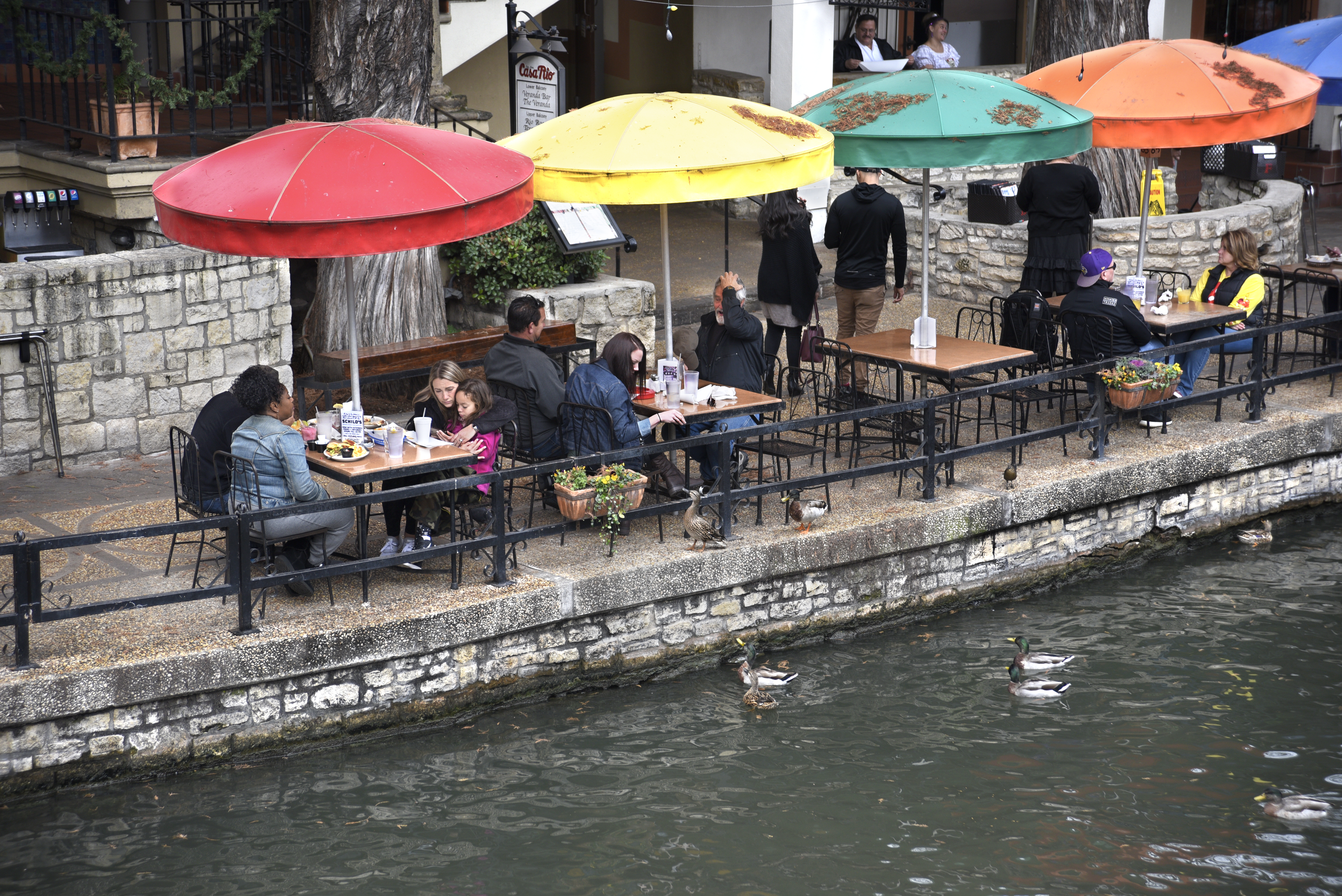 Restaurant customers enjoy their lunches beside the River Walk.