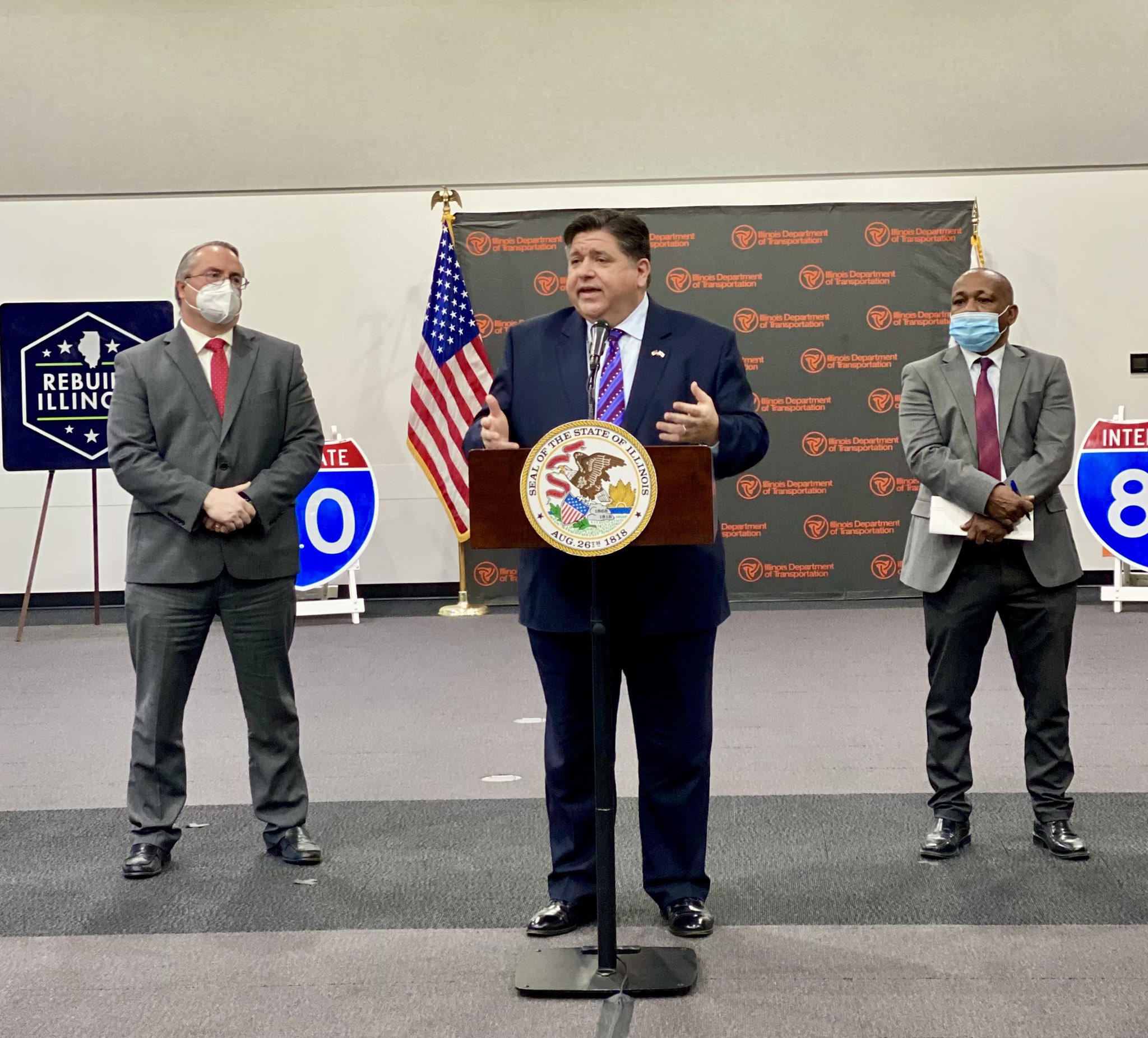 Gov. J.B. Pritzker, center, joins other state and local officials to announce construction on the new Houbolt Road bridge and interchange in Joliet on Thursday.