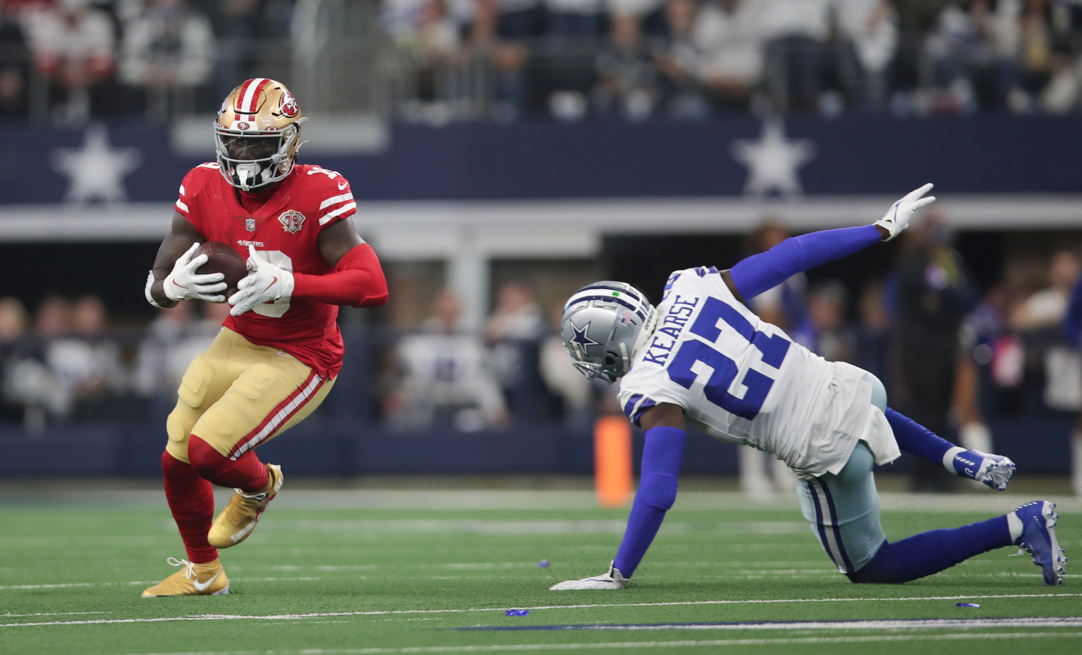 Deebo Samuel #19 of the San Francisco 49ers runs after making a catch during the NFC Wild Card Playoff game against the Dallas Cowboys at AT&amp;T Stadium on January 16, 2022 in Arlington, Texas. The 49ers defeated the Cowboys 23-17.