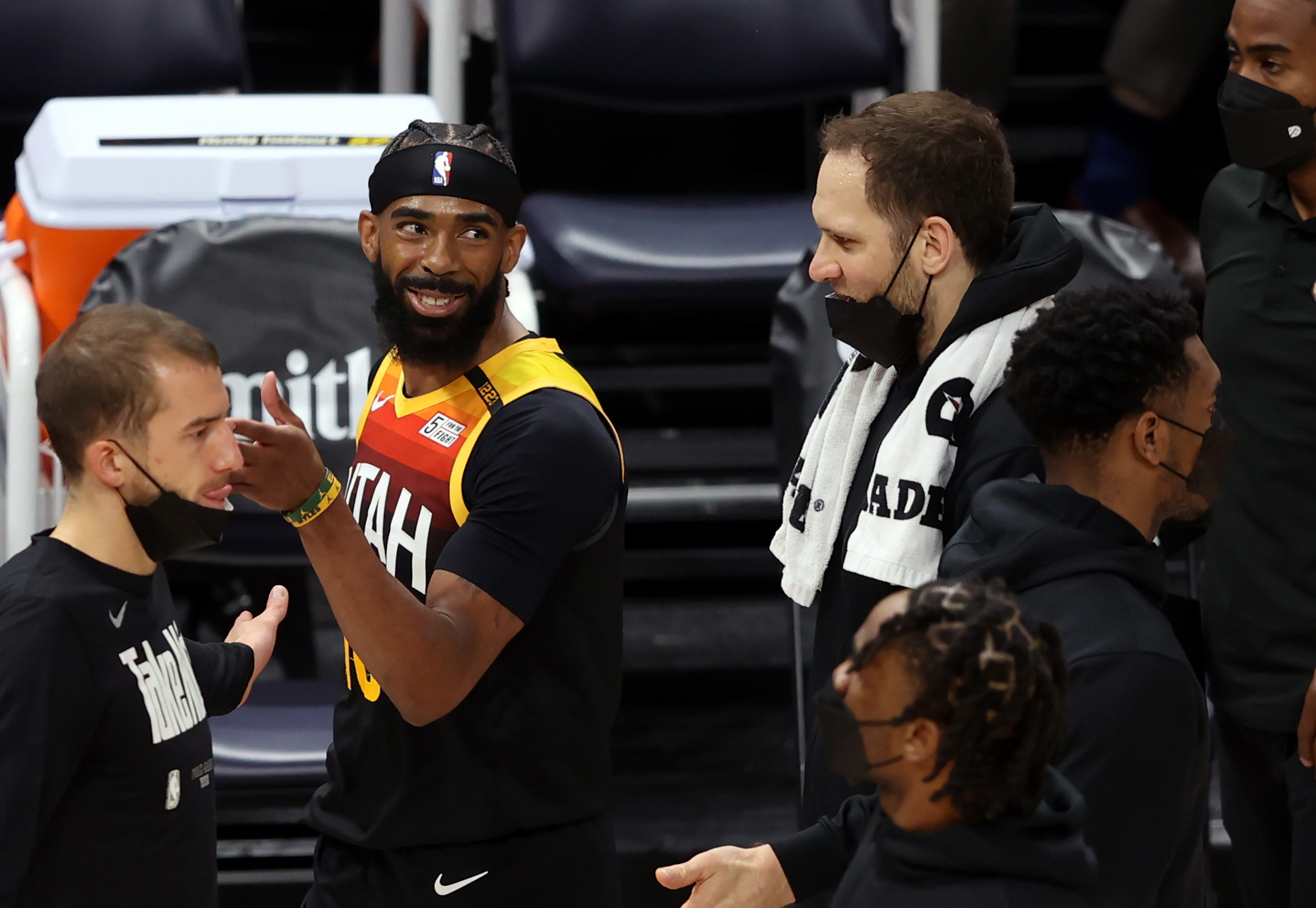 Utah Jazz guard Mike Conley smiles as he and teammate Bojan Bogdanovic talk during timeout at Vivint Arena in Salt Lake City.