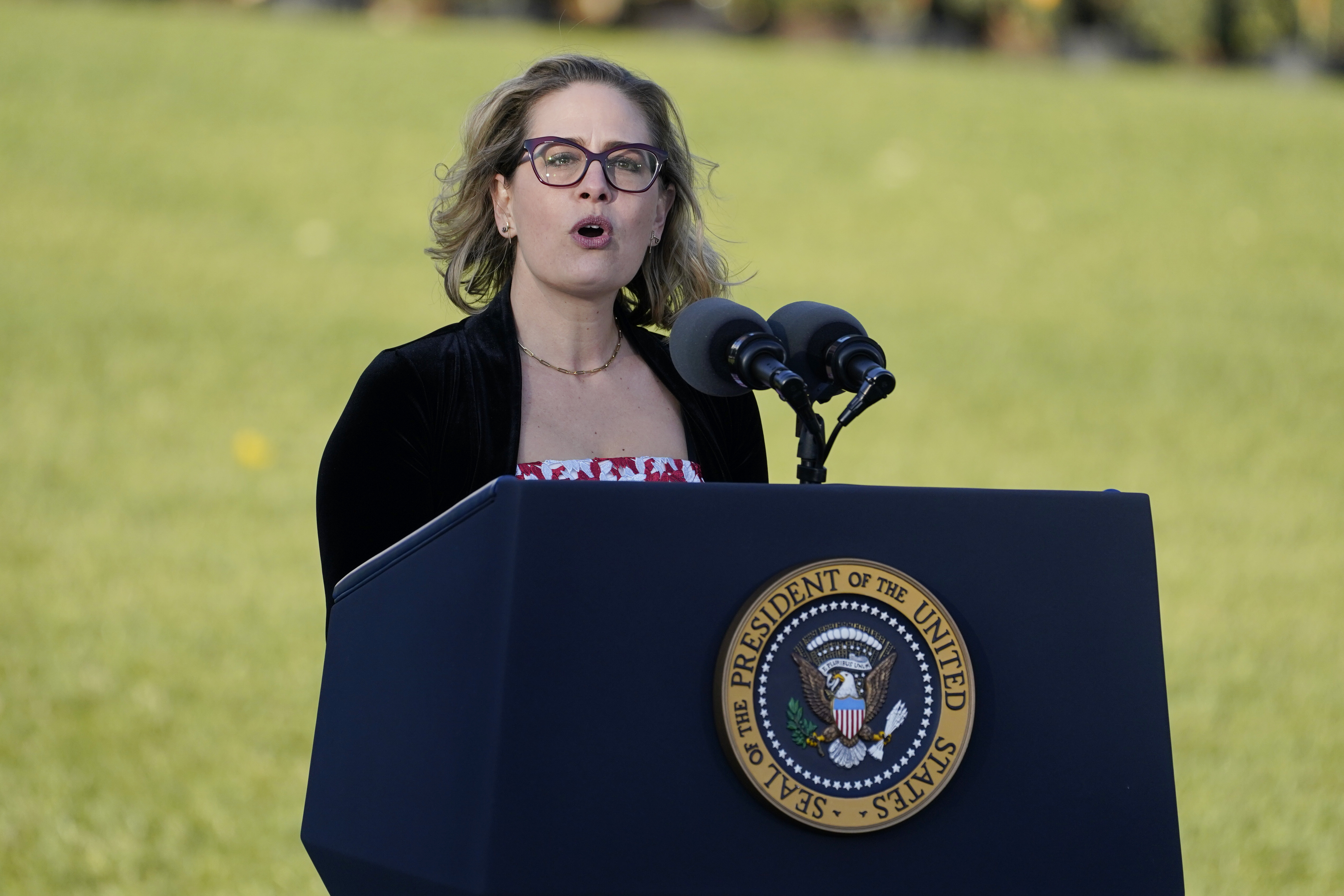 Sen. Kyrsten Sinema speaks during a ceremony on the South Lawn of the White House. 