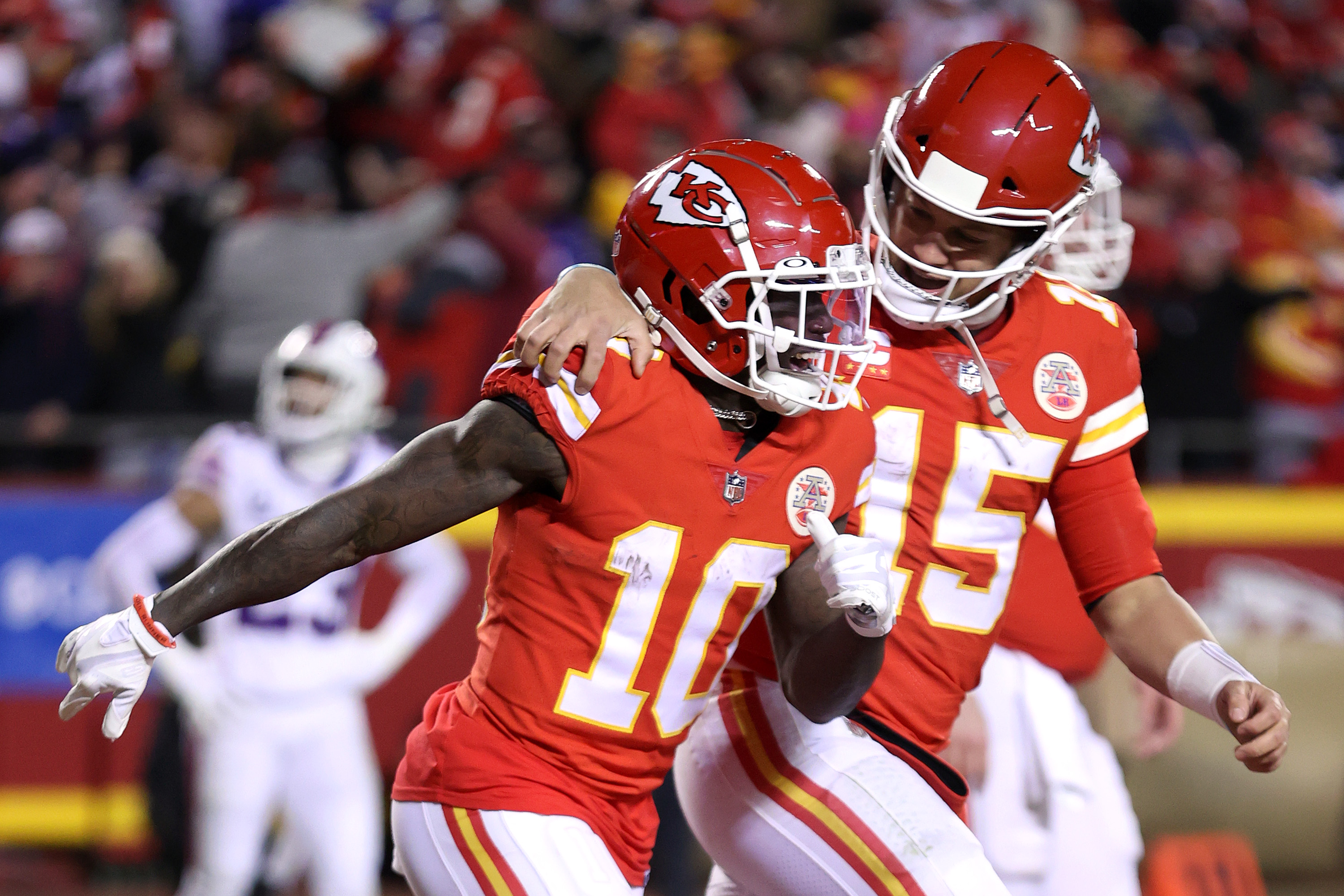 Tyreek Hill #10 of the Kansas City Chiefs celebrates with teammate Patrick Mahomes #15 after scoring a 64 yard touchdown against the Buffalo Bills during the fourth quarter in the AFC Divisional Playoff game at Arrowhead Stadium on January 23, 2022 in Kansas City, Missouri.