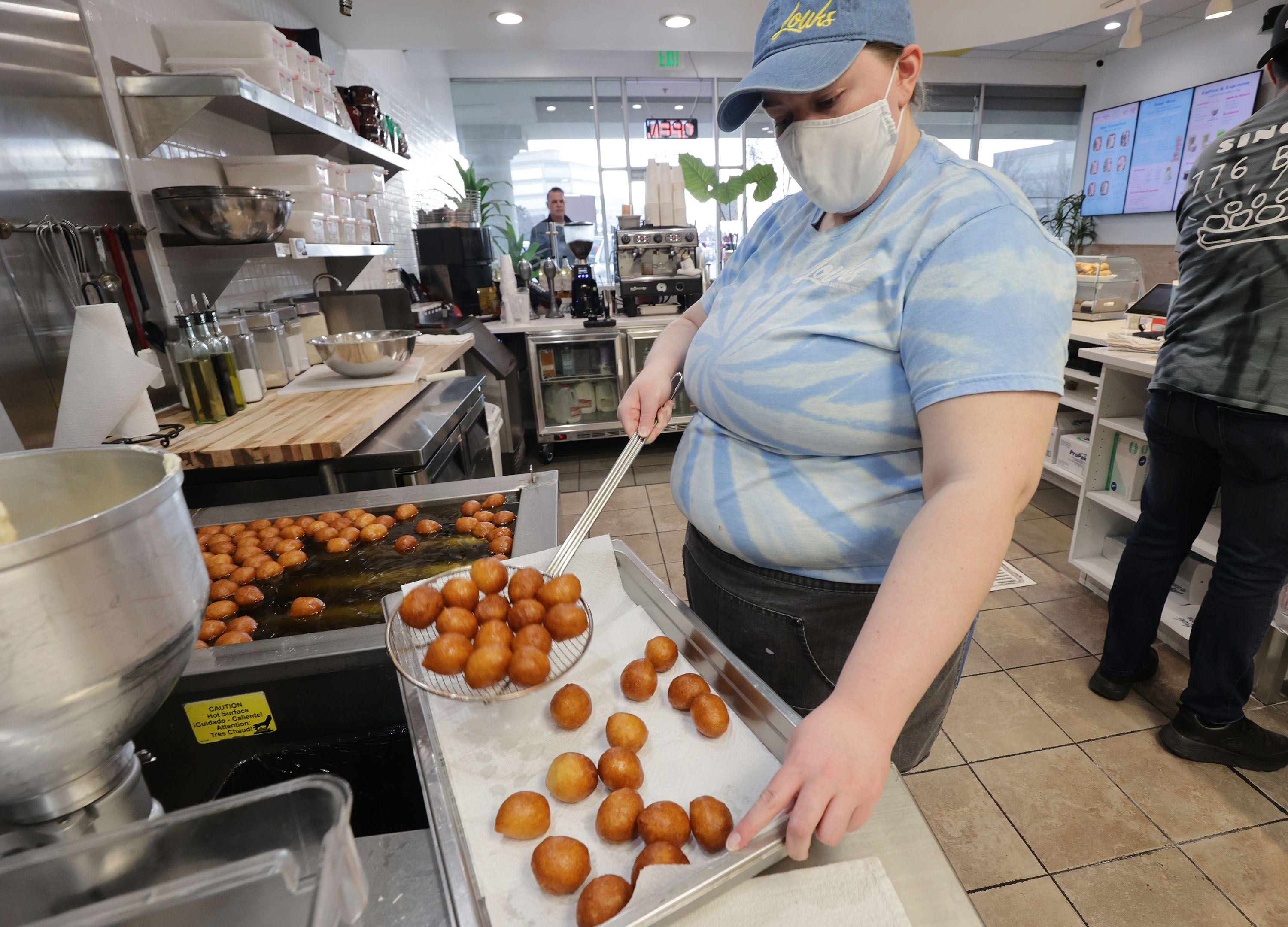 Katlynn Nebeker fries louks at Louks Greek Baby Donuts in Cottonwood Heights on Friday, Jan. 21, 2022. Louks is looking for additional workers.