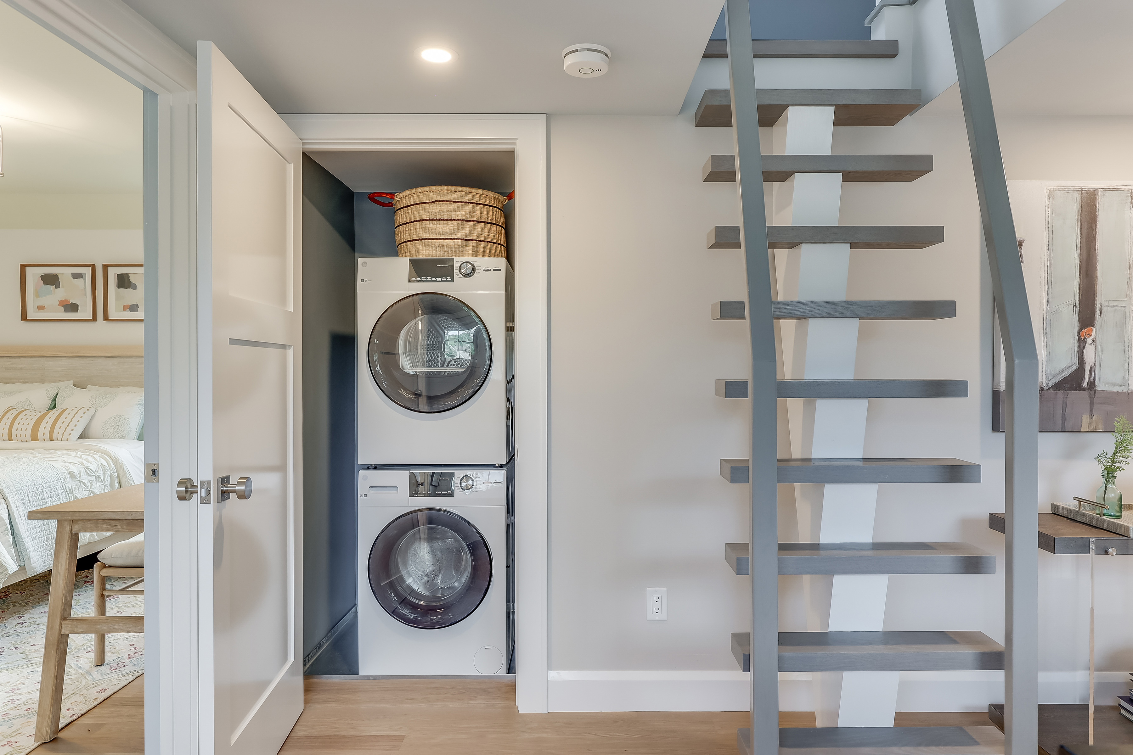 A stacked washer dryer in a closet.