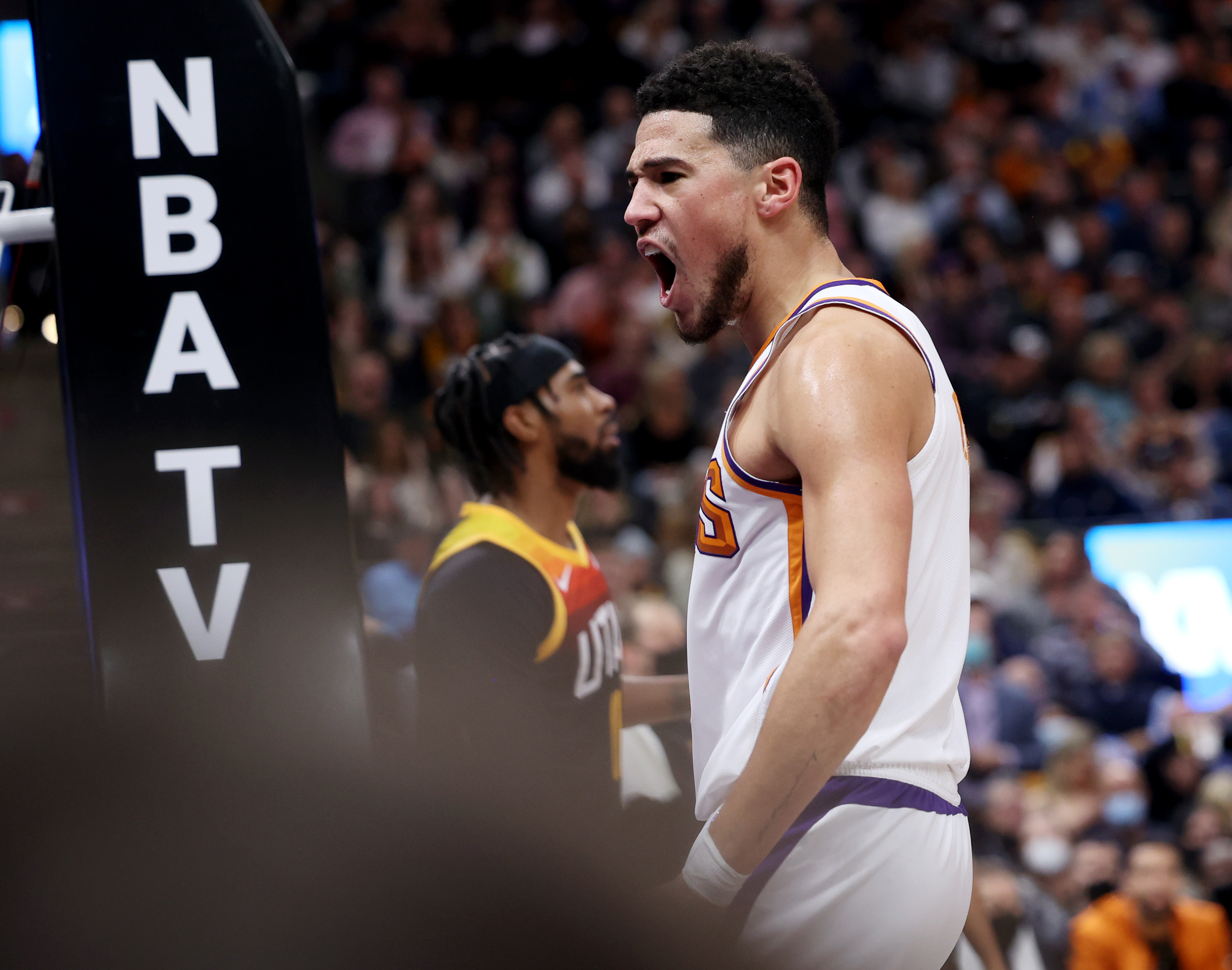 Phoenix Suns guard Devin Booker (1) yells into the crowd after making a fast brake layup as the Utah Jazz and the Phoenix Suns play an NBA basketball game in Salt Lake City at Vivint Arena on Wednesday, Jan. 26, 2022.