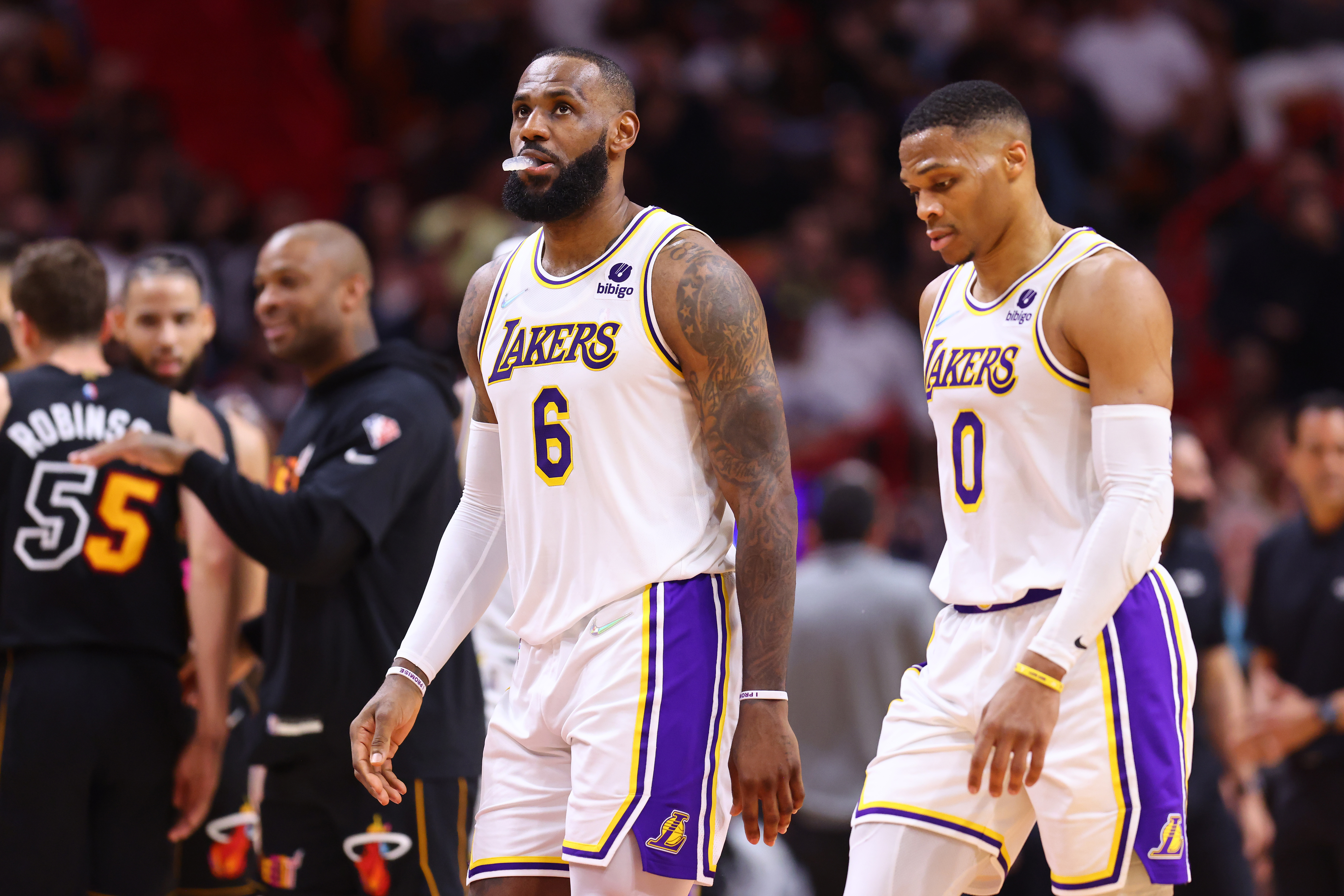 LeBron James #6 and Russell Westbrook #0 of the Los Angeles Lakers react against the Miami Heat during the first half at FTX Arena on January 23, 2022 in Miami, Florida.