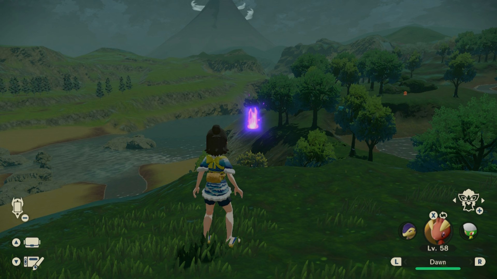 A Pokémon trainer stands in front of a purple glowing flame at night