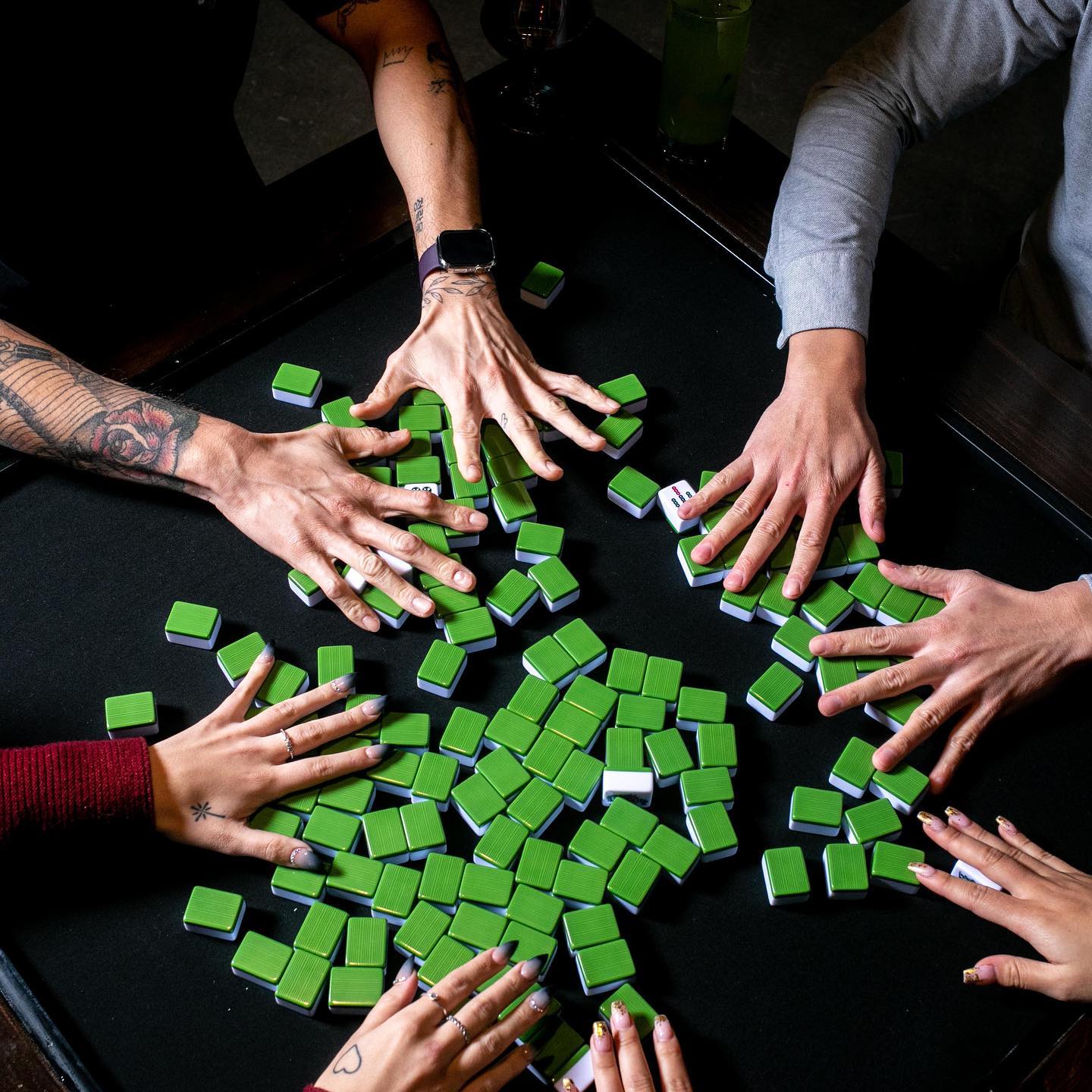 green mahjong tiles on a table