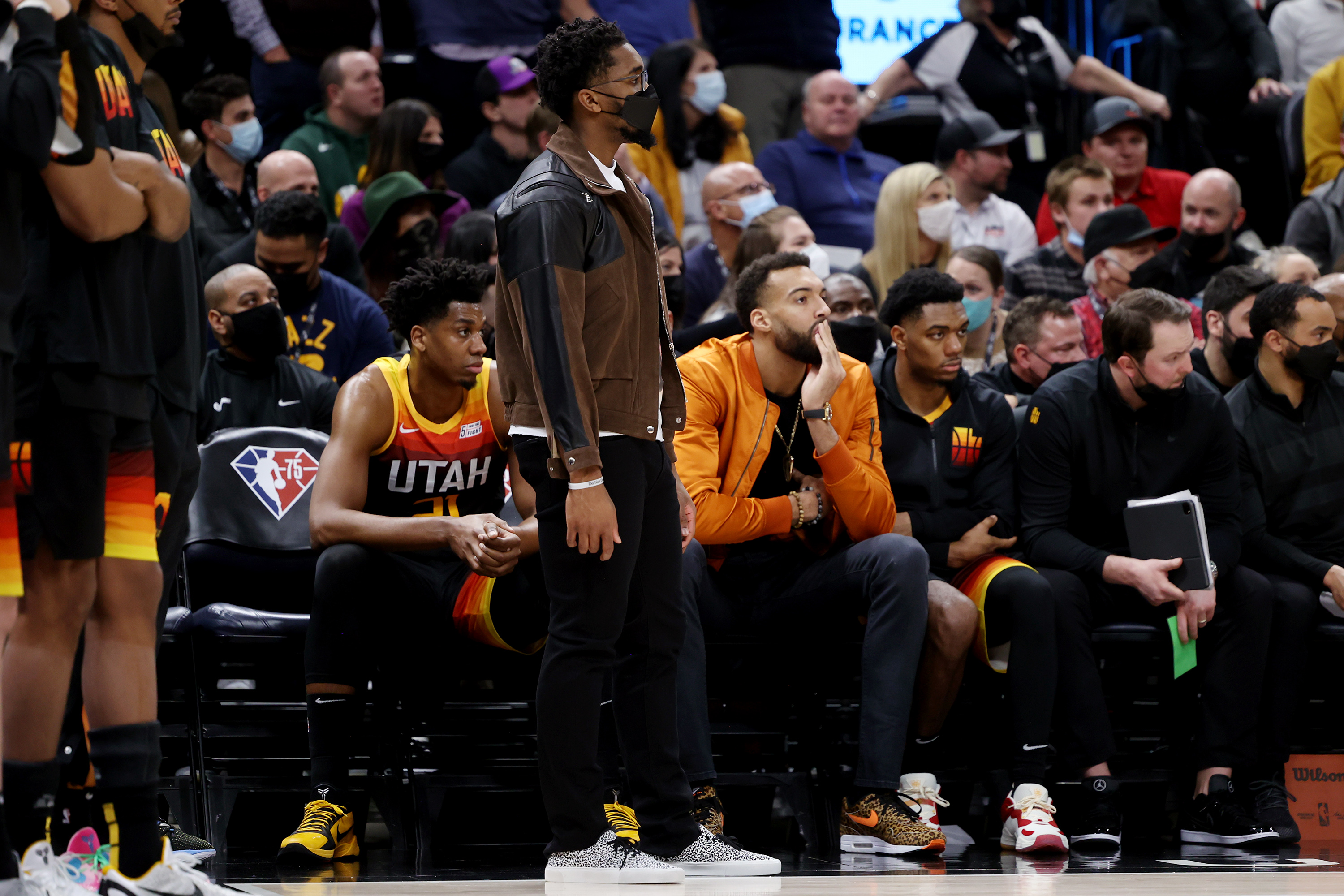 Utah Jazz’s Donovan Mitchell and Rudy Gobert watch from the bench in street clothes as Jazz and Suns play in Salt Lake City.