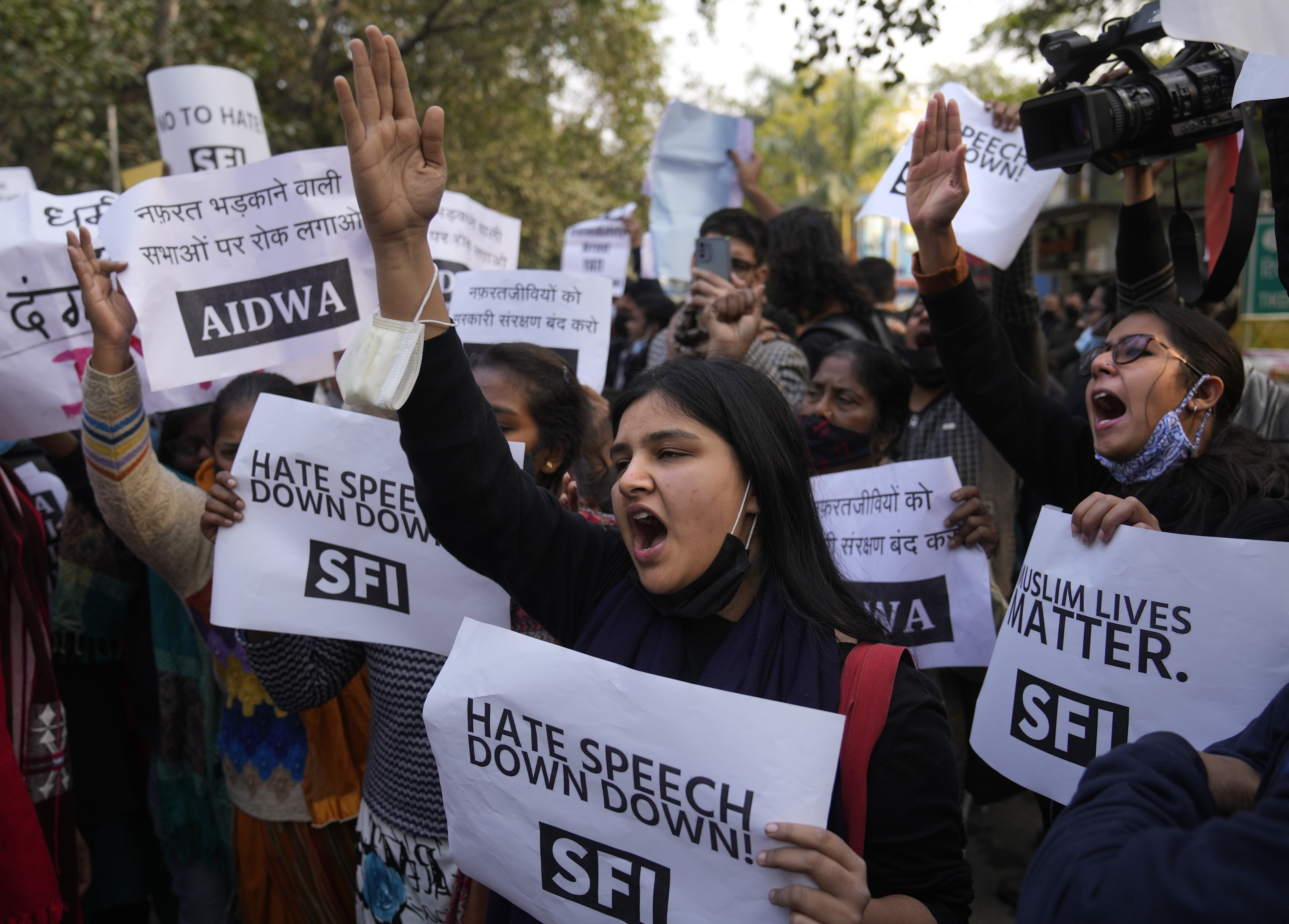 Activists shout slogans during a protest against hate speech in New Delhi, India, Dec.27, 2021. 