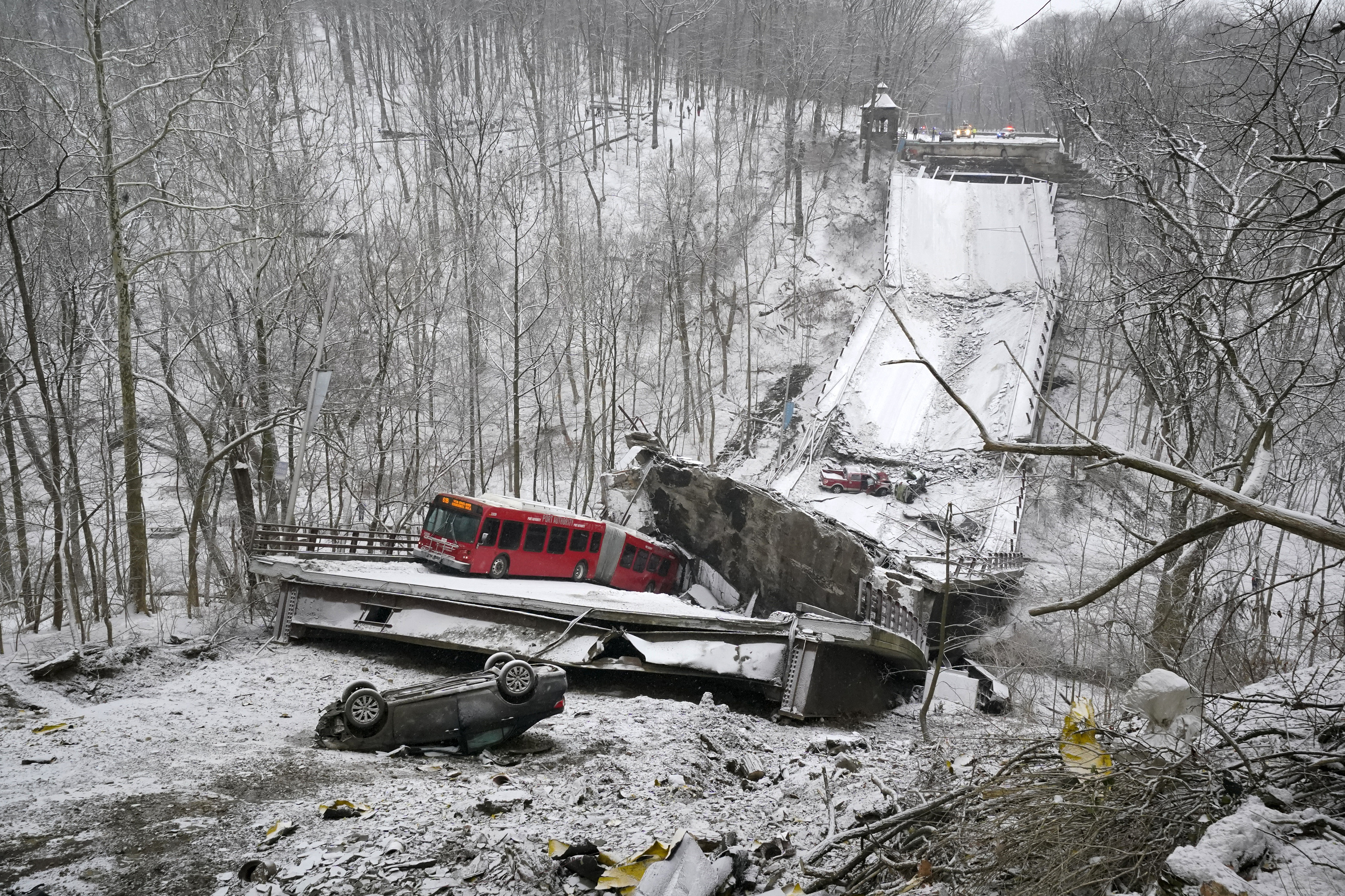 A Port Authority bus that was on a bridge when it collapsed Friday Jan. 28, 2022, is visible in Pittsburgh’s East End.