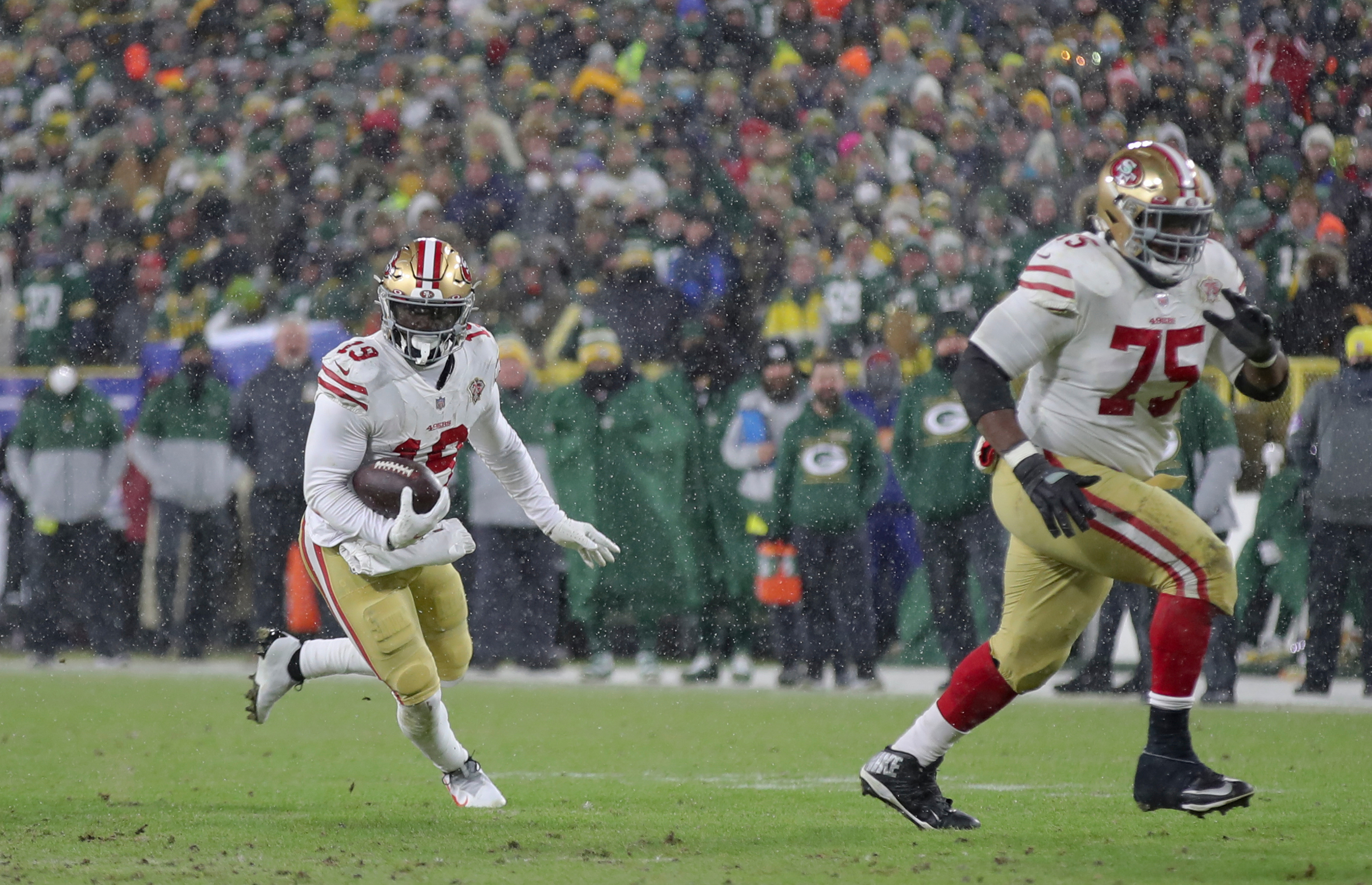 Deebo Samuel #19 of the San Francisco 49ers runs after making a catch during the game against the Green Bay Packers in the NFC Divisional Playoff game at Lambeau Field on January 22, 2022 in Green Bay, Wisconsin. The 49ers defeated the Packers 13-10.