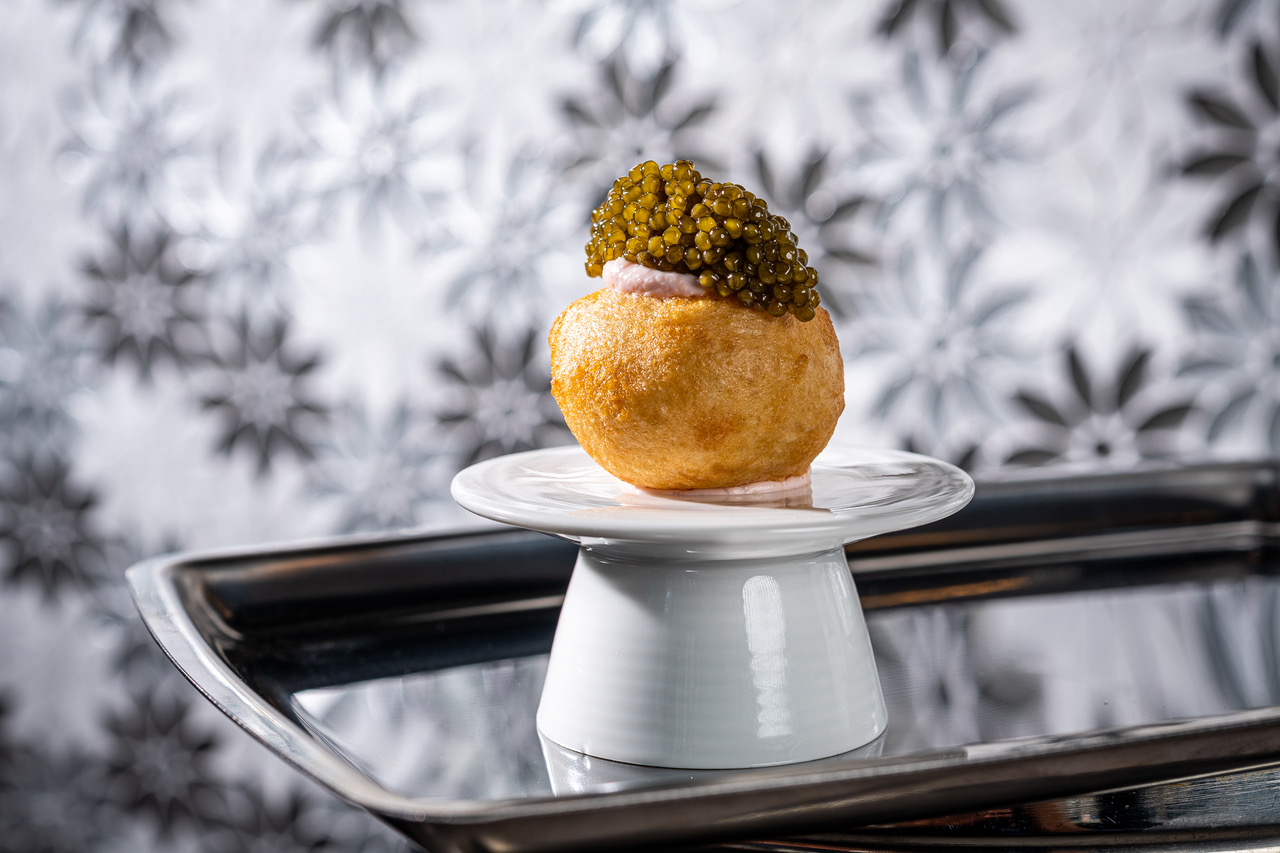 Loukoumades, a savory doughnut filled with taramasalata and topped with Golden Osetra Caviar.