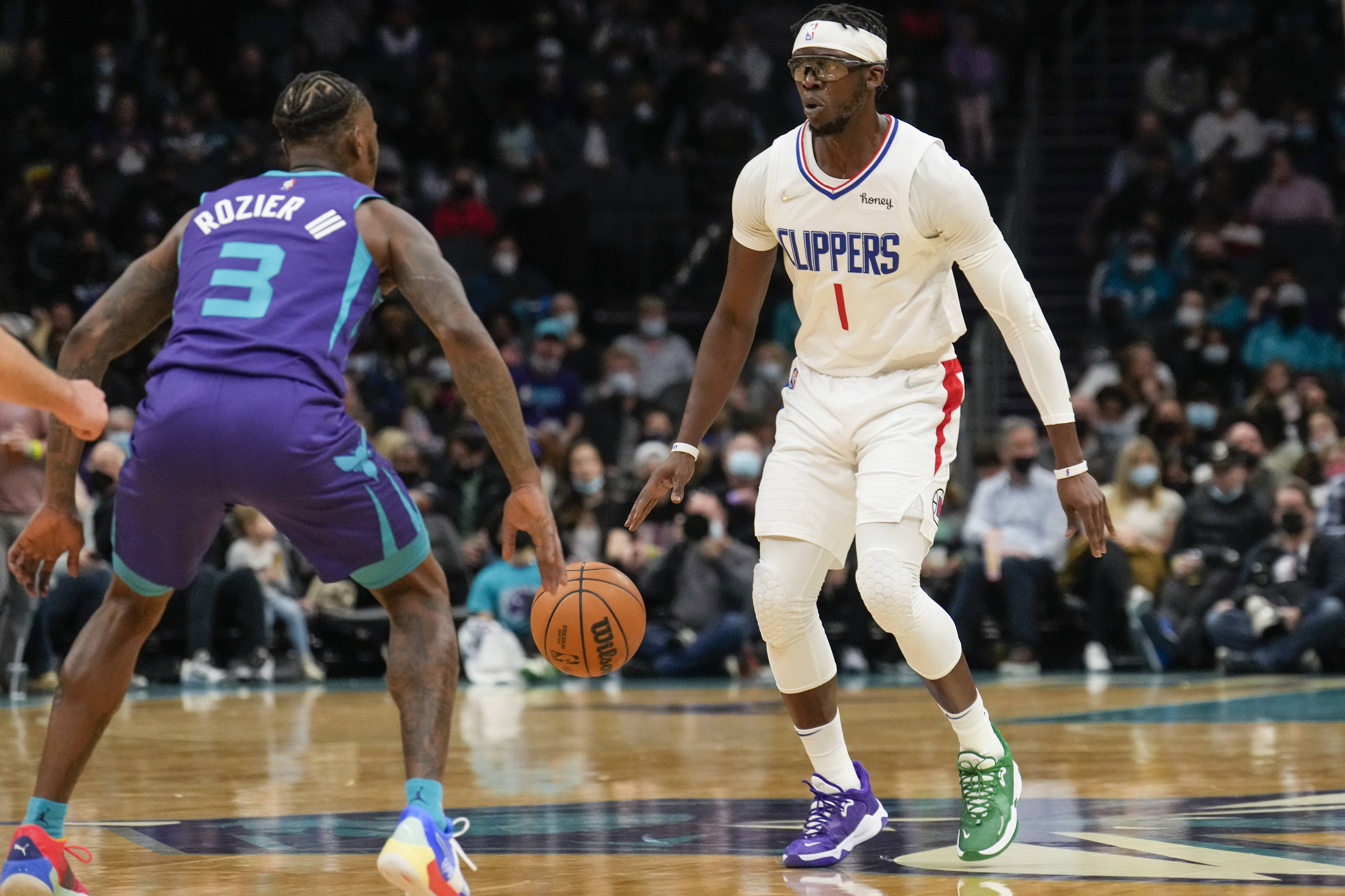 LA Clippers guard Reggie Jackson (1) on the dribble covered by Charlotte Hornets guard Terry Rozier (3) during the second half at the Spectrum Center.