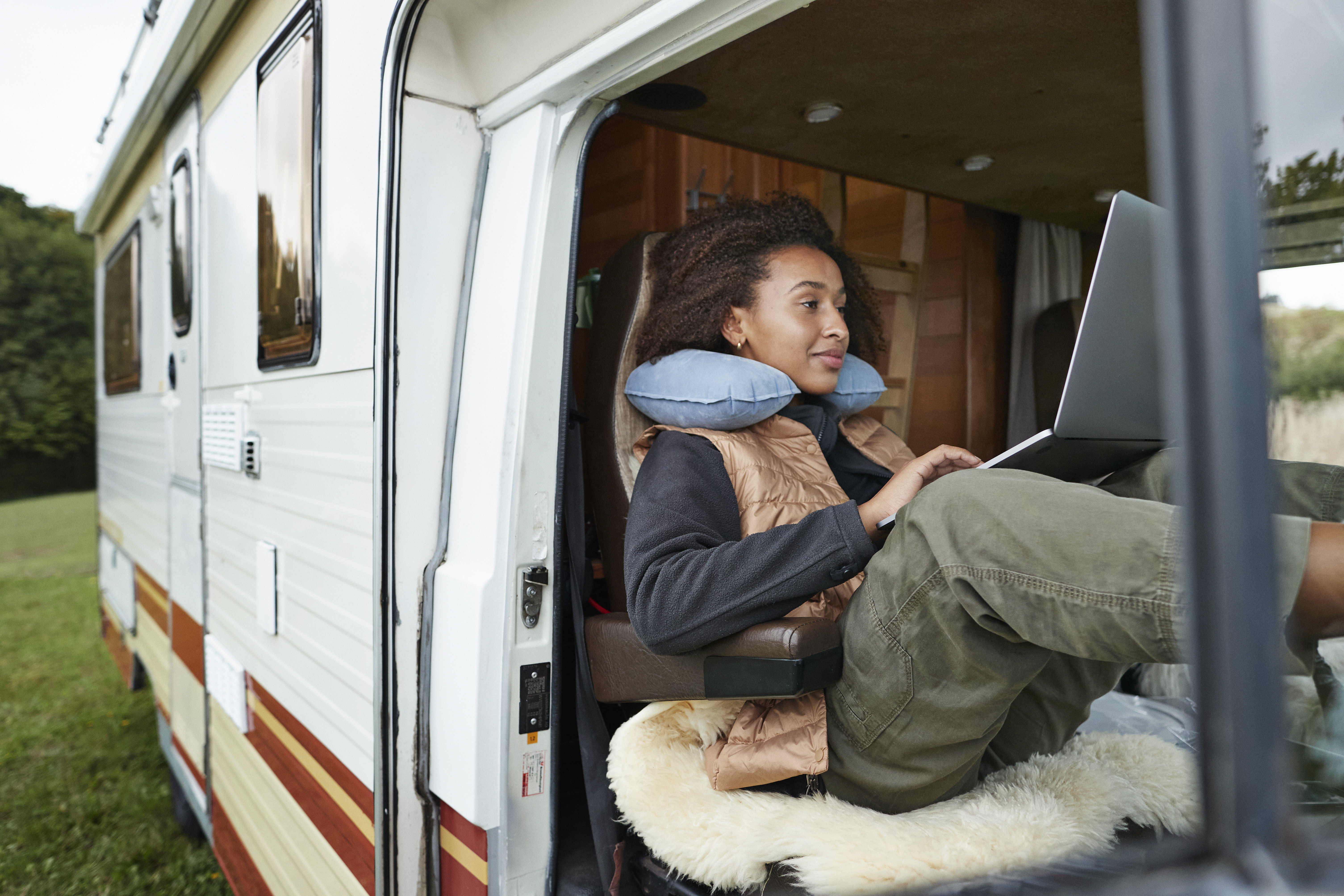Woman working in an RV on her laptop.