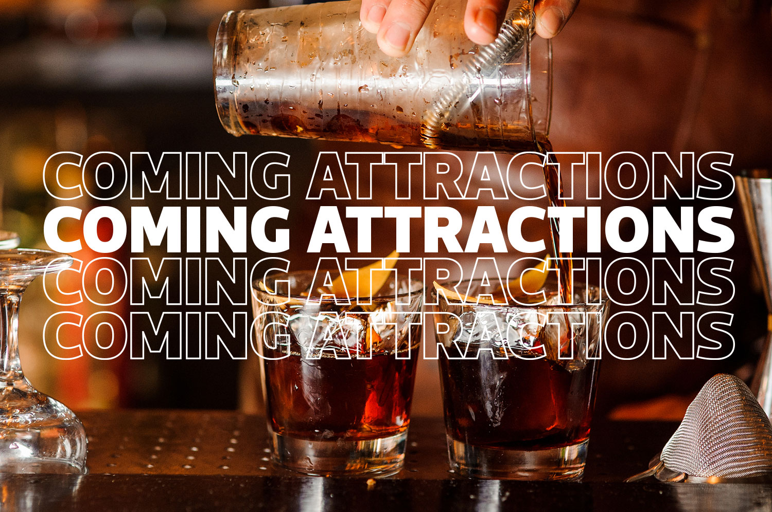 A person’s hand pours a drink out of a copper shaker into a rocks glass. The words “coming attractions” are overlaid in white.