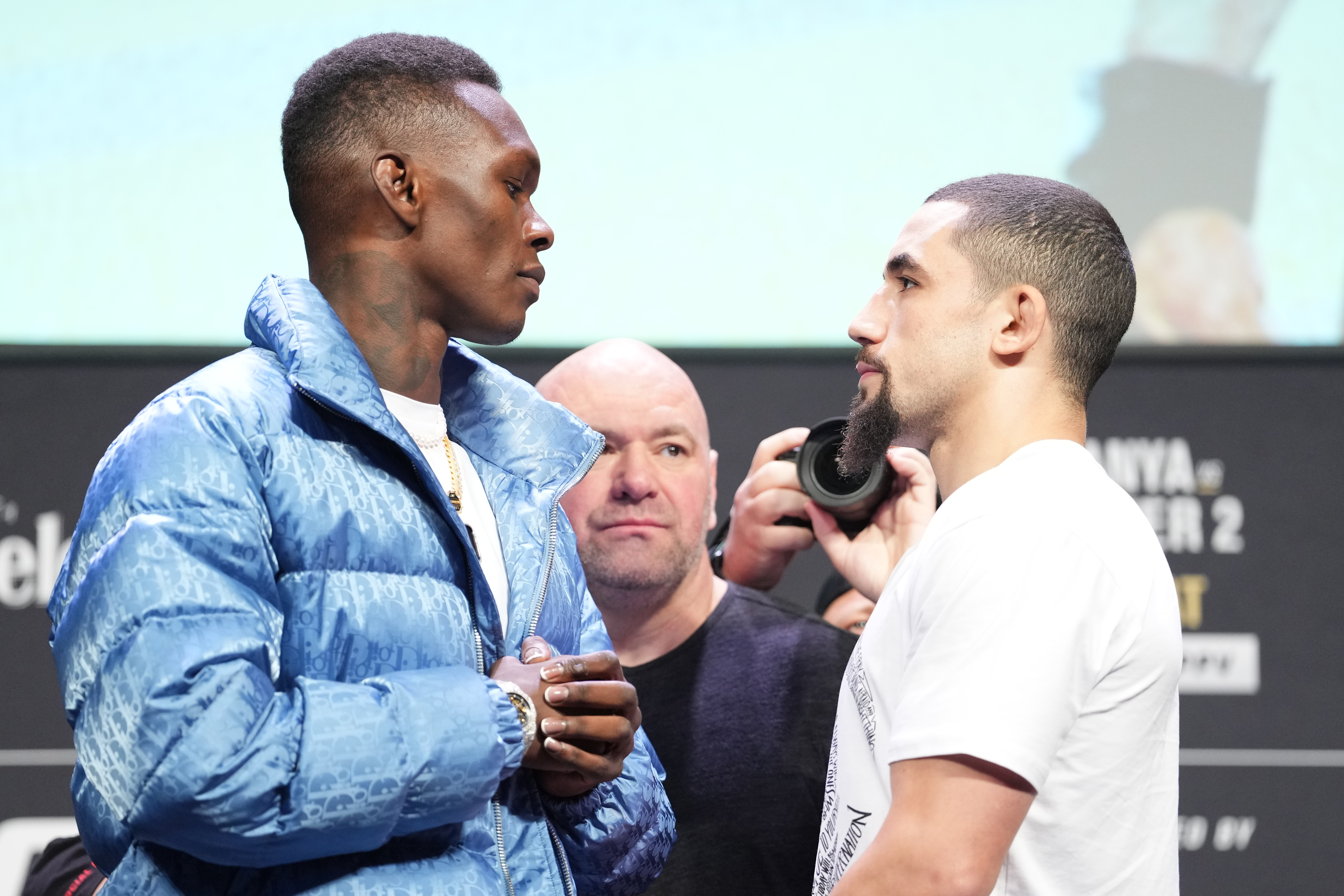 Opponents Israel Adesanya of Nigeria and Robert Whittaker of Australia face off during the UFC 271 press conference at George R. Brown Convention Center on February 10, 2022 in Houston, Texas.