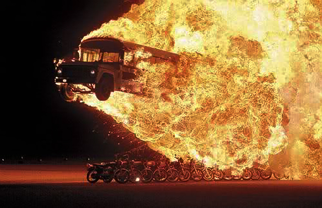 Flaming Bus Jumping over a line of motorcycles.