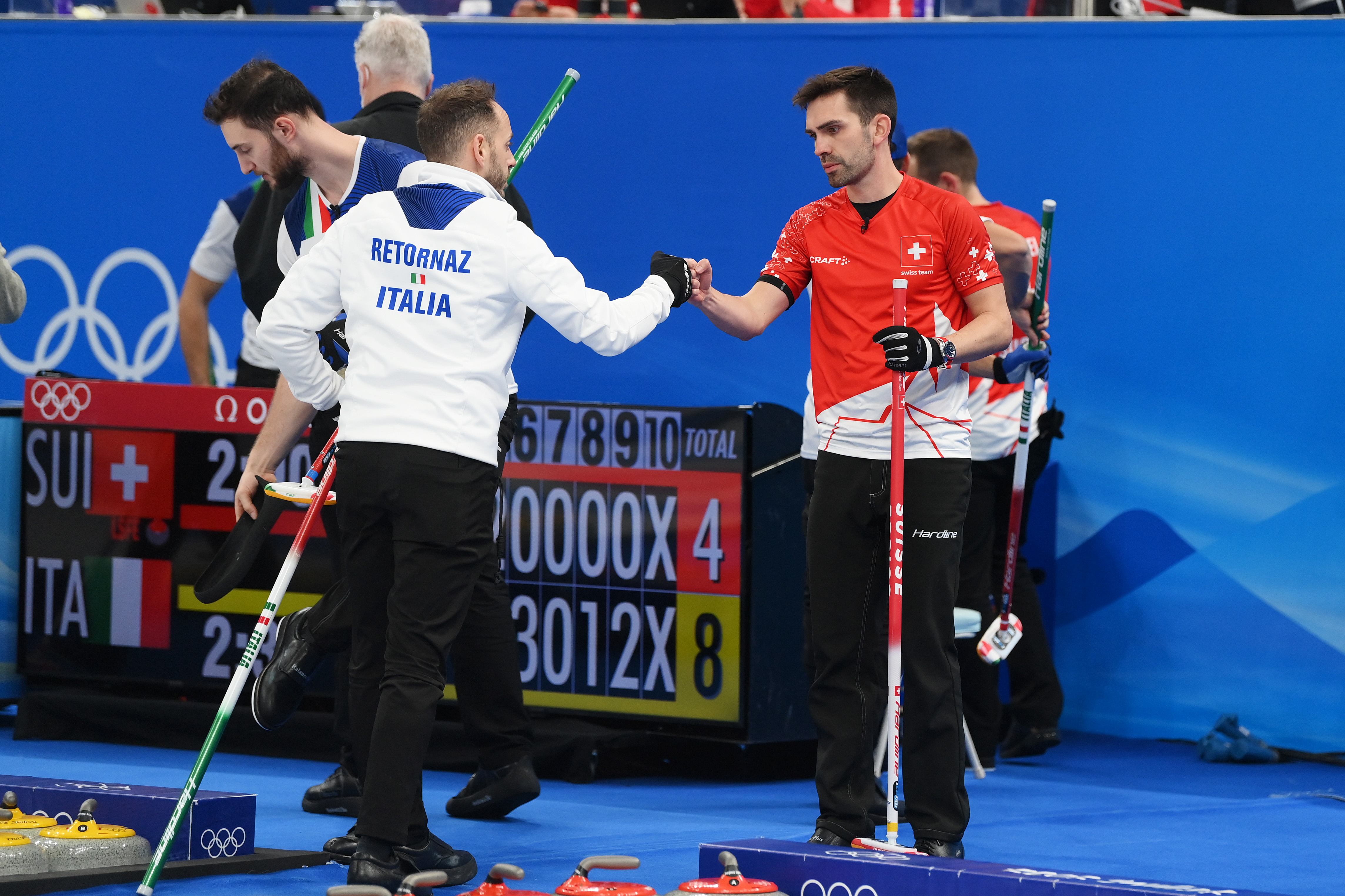Joel Retornaz of Team Italy interacts with Peter De Cruz of Team Switzerland following their sides victory during the Men’s Curling Round Robin Session 7 on Day 9 of the Beijing 2022 Winter Olympic Games at National Aquatics Centre on February 13, 2022 in Beijing, China.
