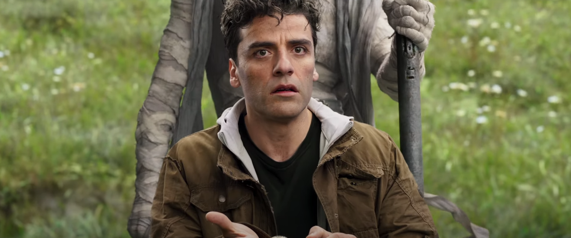 Oscar Isaac in Moon Knight with someone standing behind him