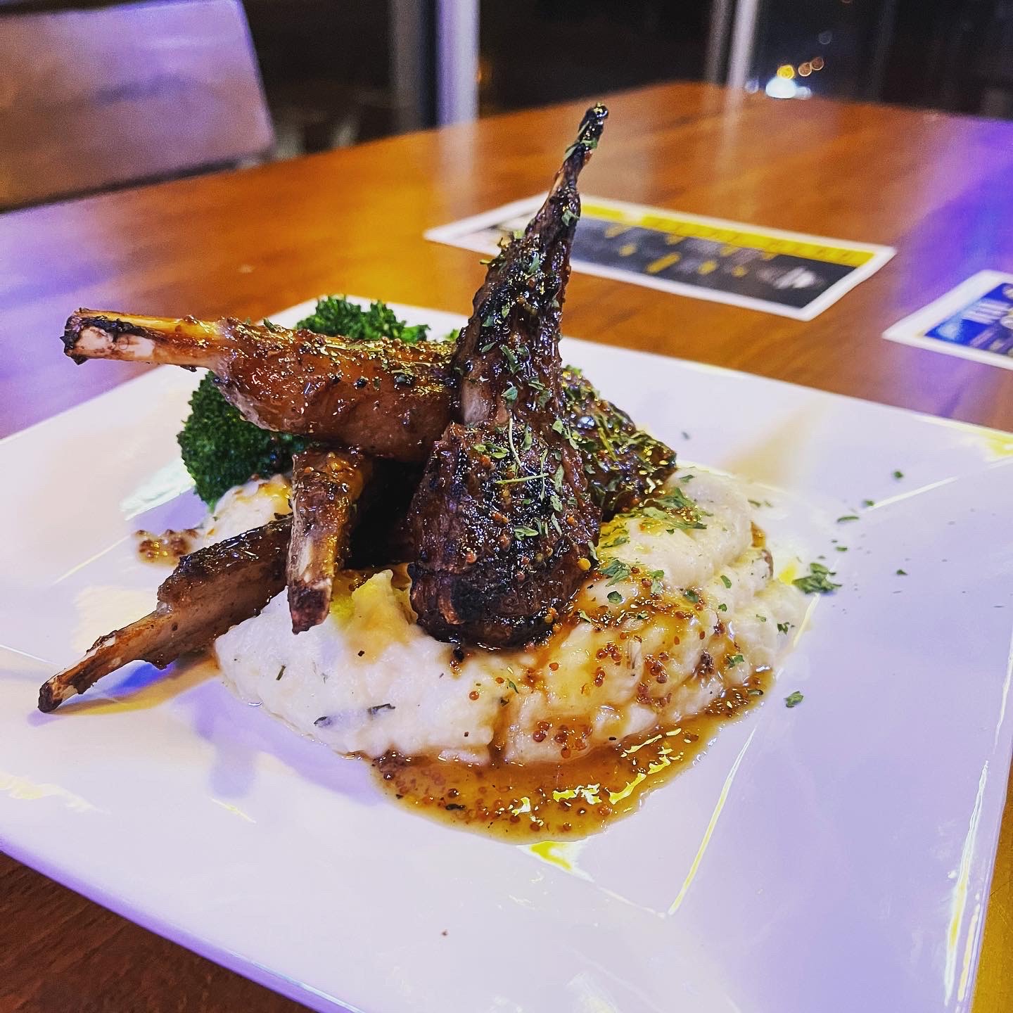 Lollipop lamb chops served atop herby mashed potatoes at Augustine’s Bar and Grill in Grant Park, ATlanta. 