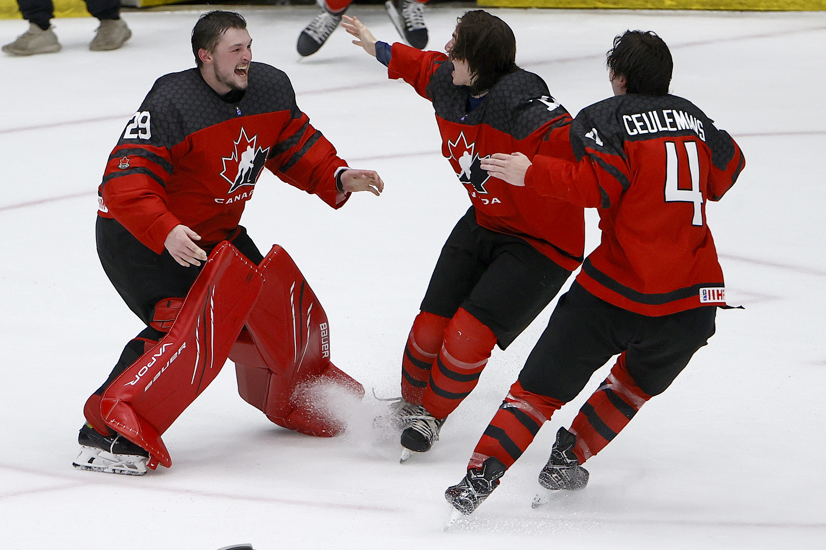 Benjamin Gaudreau #29 of Canada, Conner Roulette #12 of Canada and Corson Ceulemans #4 of Canada celebrate after defeating Russia 5-3 in the 2021 IIHF Ice Hockey U18 World Championship Gold Medal Game at Comerica Center on May 06, 2021 in Frisco, Texas.