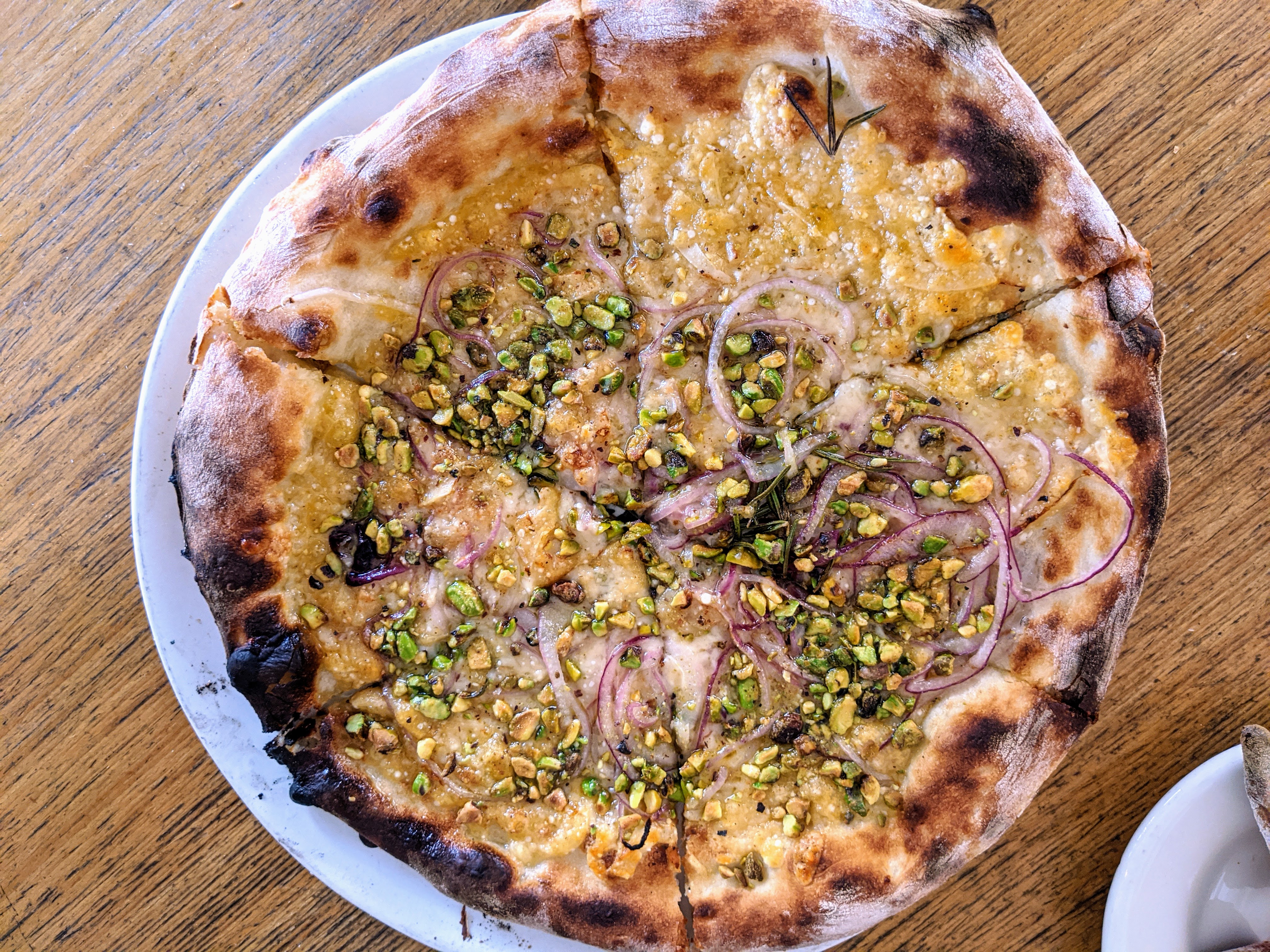 Rosa pizza from Pizzeria Bianco in Phoenix with pistachios, red onions, parmesan, and rosemary.