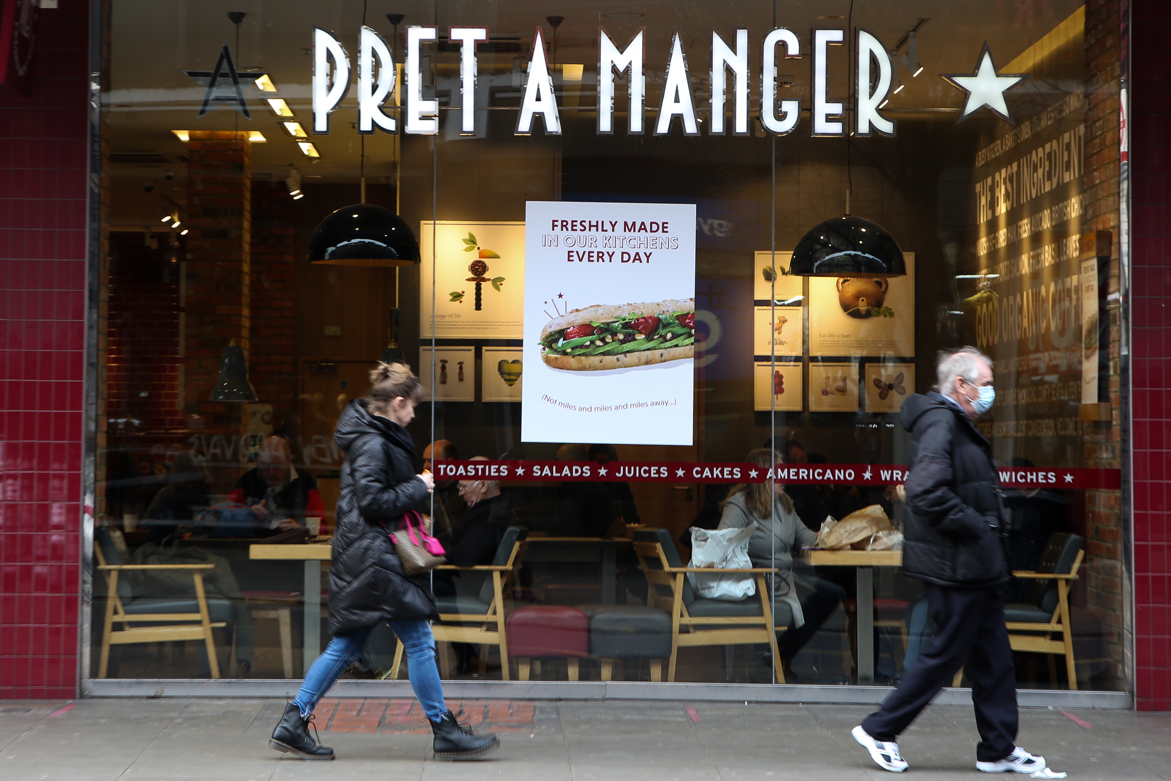 People walk past a branch of Pret-A-Manger