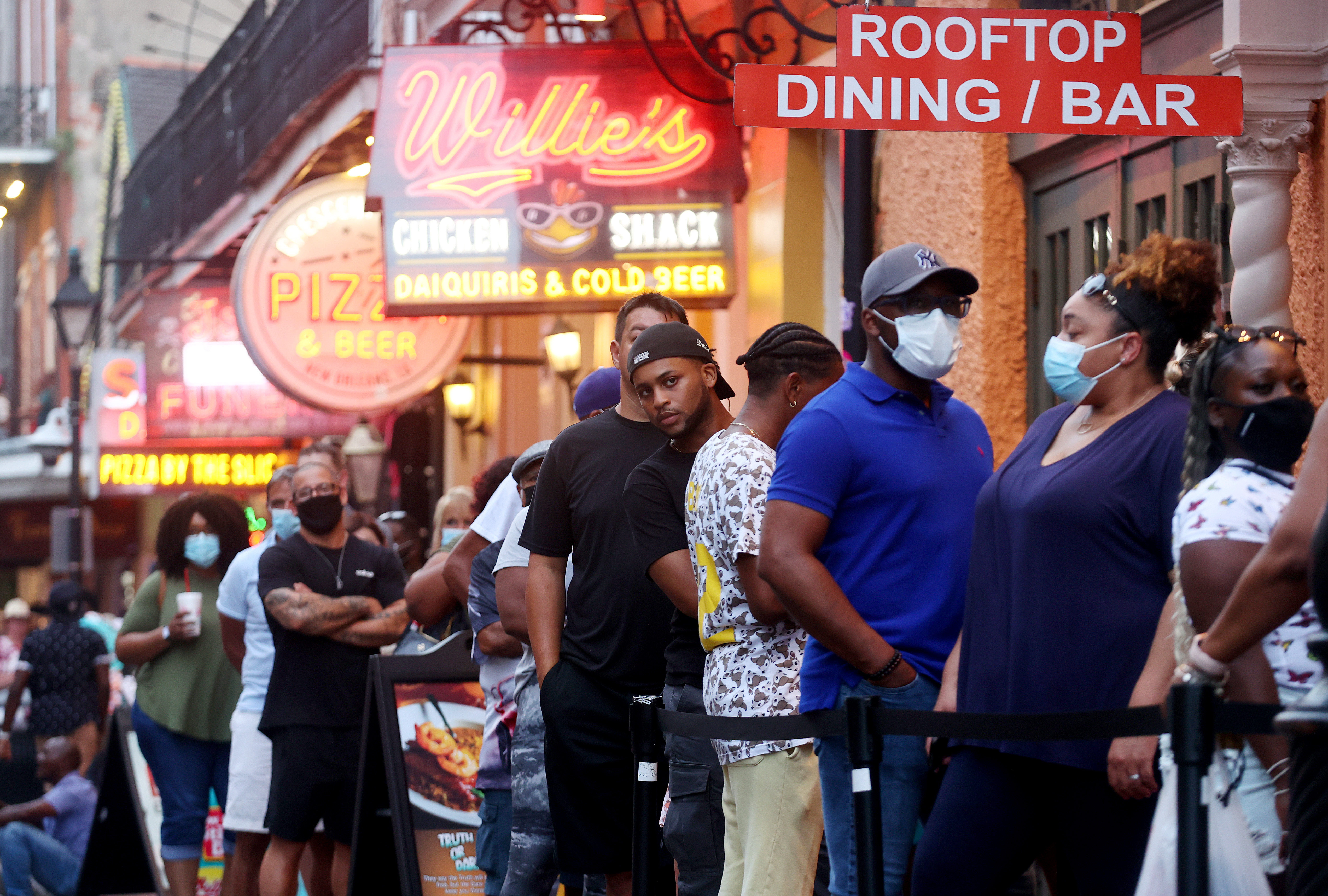 People wait in line to enter a restaurant in the French Quarter on August 13, 2021 in New Orleans, Louisiana. 
