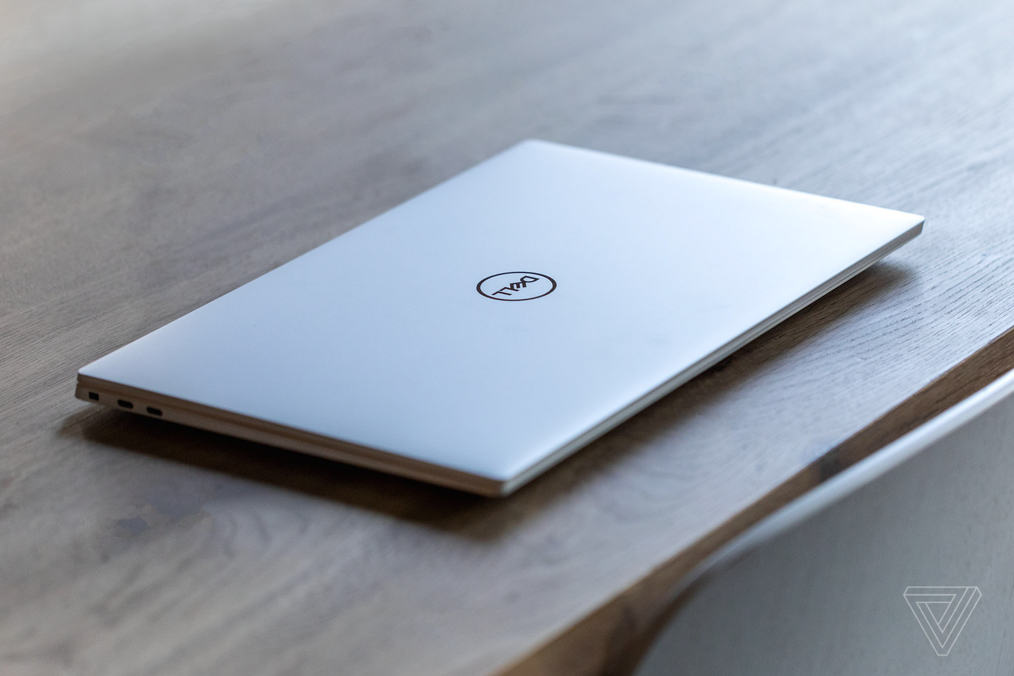 The Dell XPS 15 closed on a wooden table.