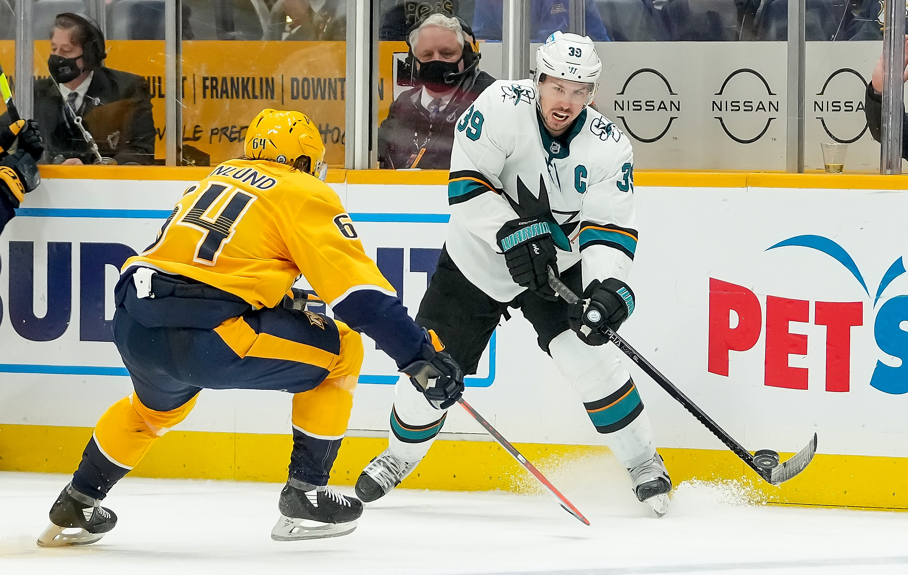 Logan Couture #39 of the San Jose Sharks skates against Mikael Granlund #64 of the Nashville Predators during an NHL game at Bridgestone Arena on October 26, 2021 in Nashville, Tennessee.