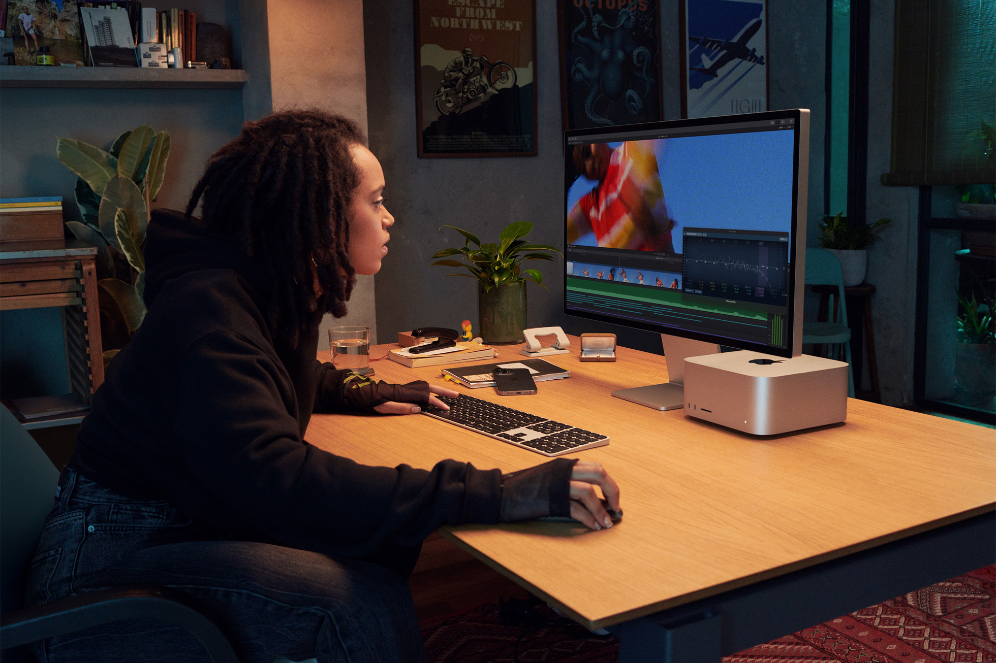 A user works on the Mac Studio and Mac Studio Display.