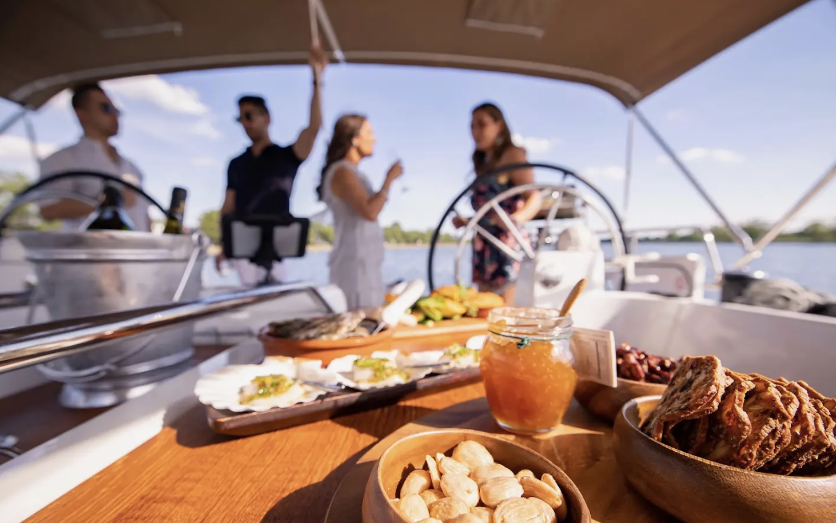 Appetizers on a boat with four people in the background