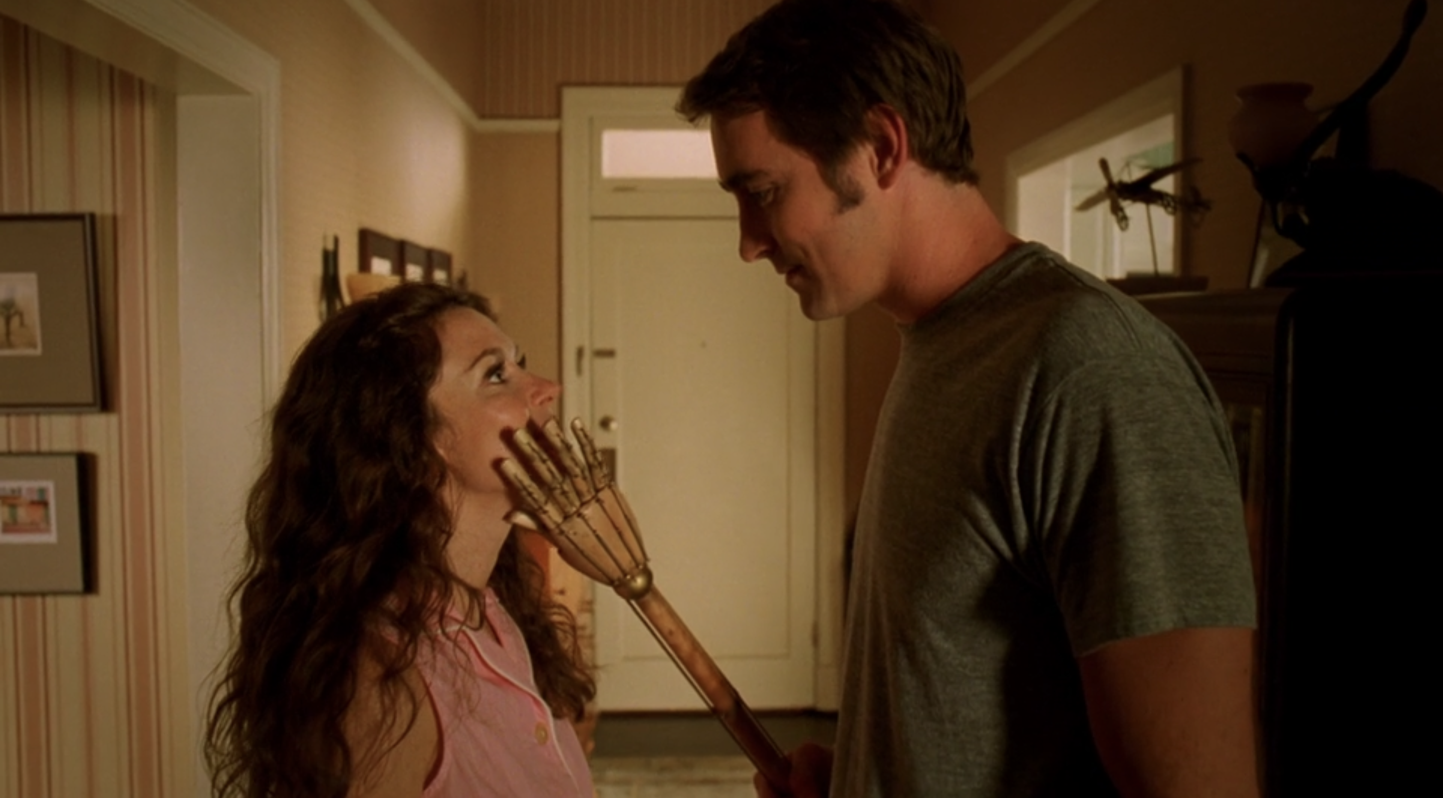 Ned touching Chuck’s face with a wooden hand in Pushing Daisies