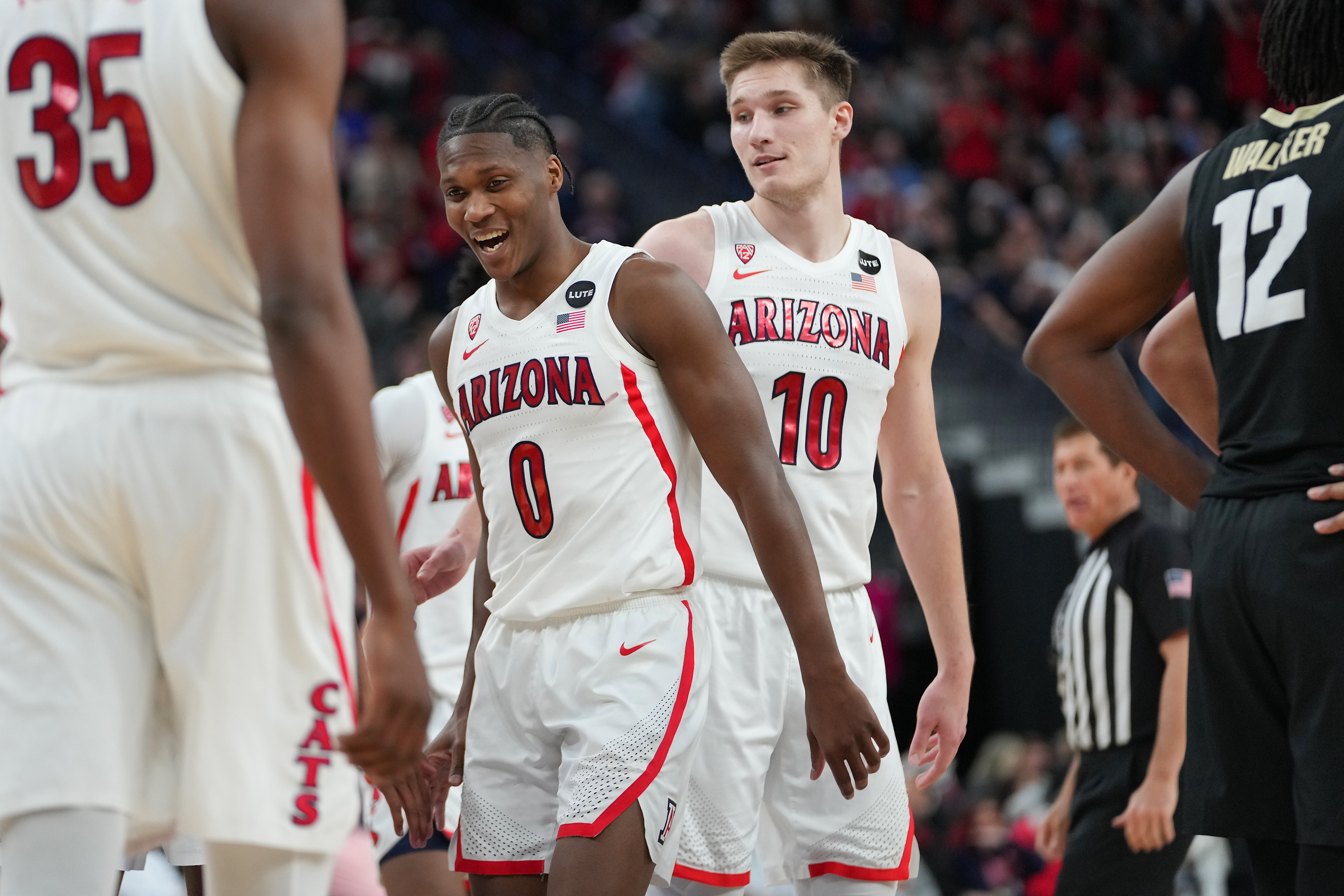 Arizona Wildcats guard Bennedict Mathurin and Arizona Wildcats forward Azuolas Tubelis celebrate after the Wildcats defeated the Colorado Buffaloes 82-72 at T-Mobile Arena.