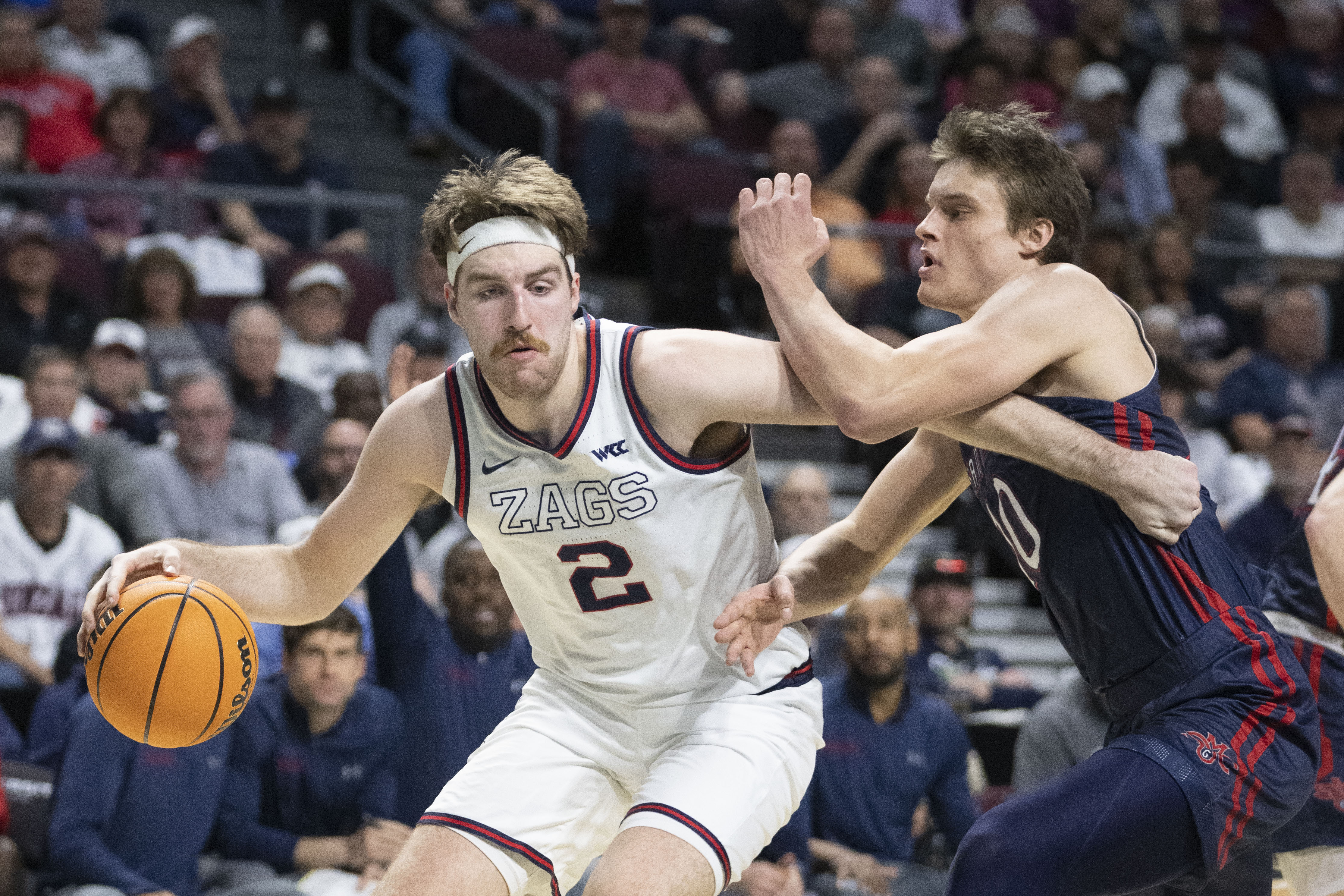 Gonzaga Bulldogs forward Drew Timme (2) dribbles the basketball against Saint Mary’s Gaels center Mitchell Saxen (10) during the first half in the finals of the WCC Basketball Championships at Orleans Arena.