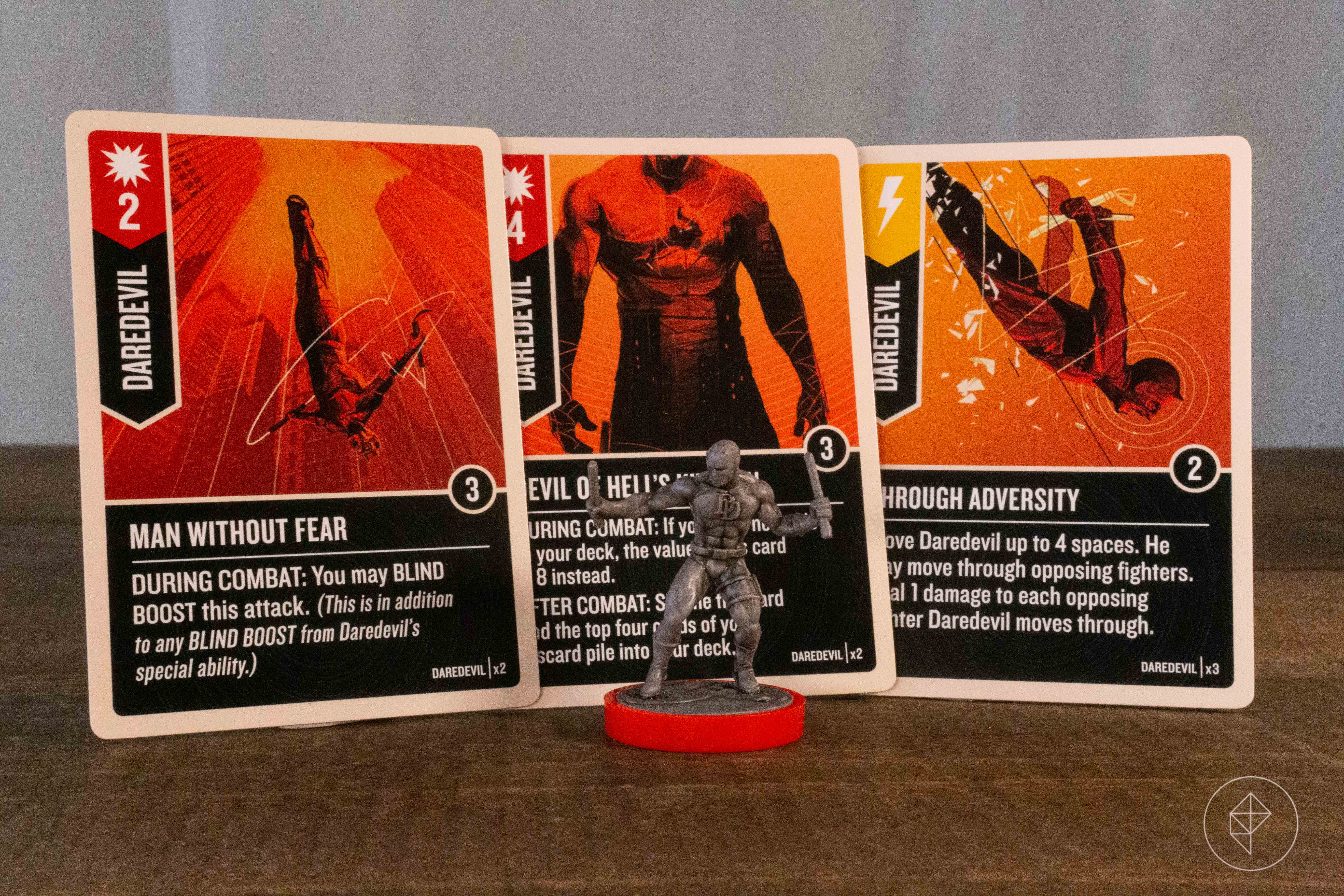 A Daredevil miniature with three related cards from the character’s deck.