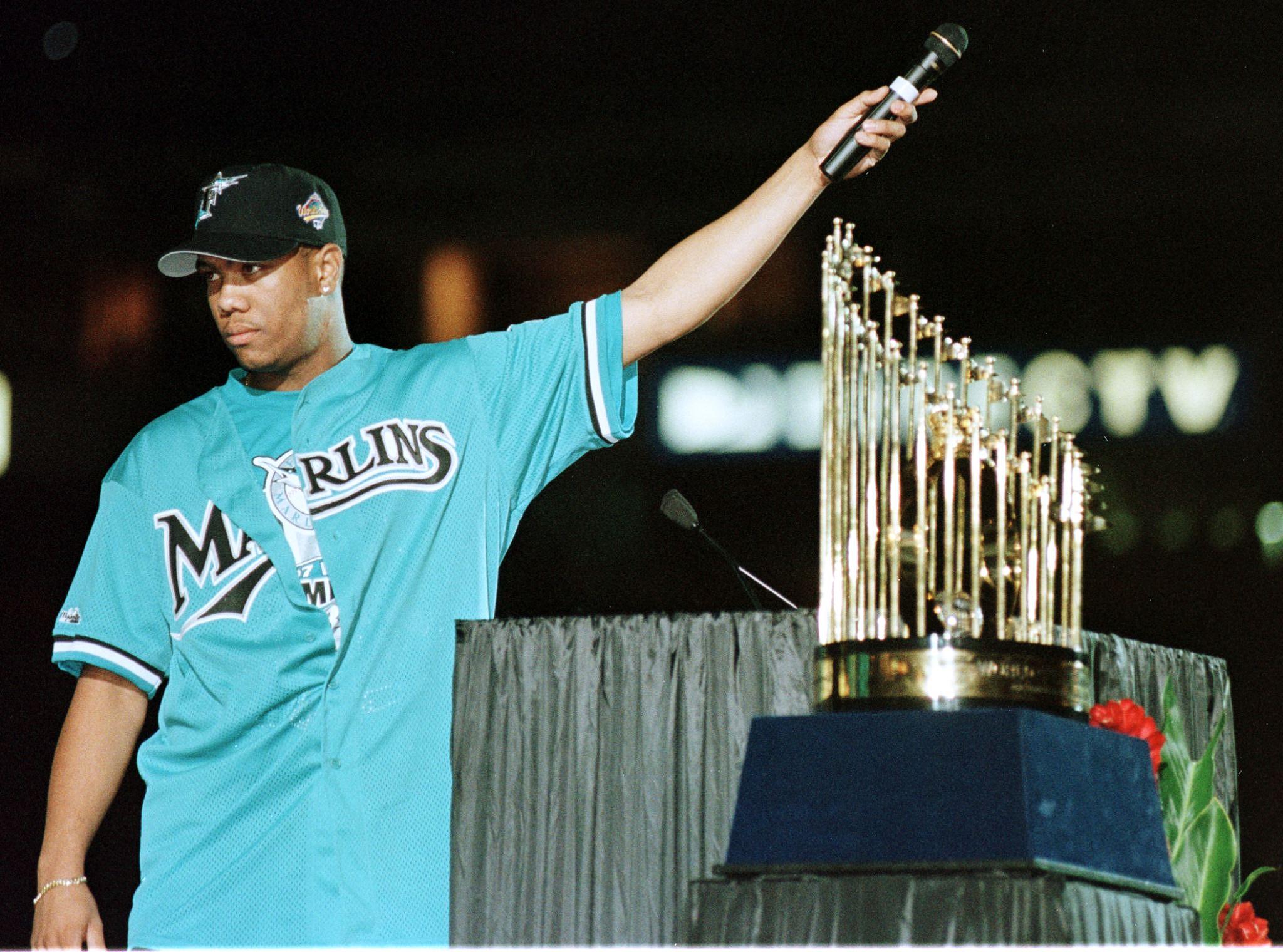Florida Marlin pitcher and World Series Most Valuable Player Livan Hernandez holds the microphone to the crowd as they cheer at a rally held for the Florida Marlins 28 October at Pro Player Stadium in Miami, Florida. The Marlins Beat the Cleveland Indians of the American League in a best of seven-series