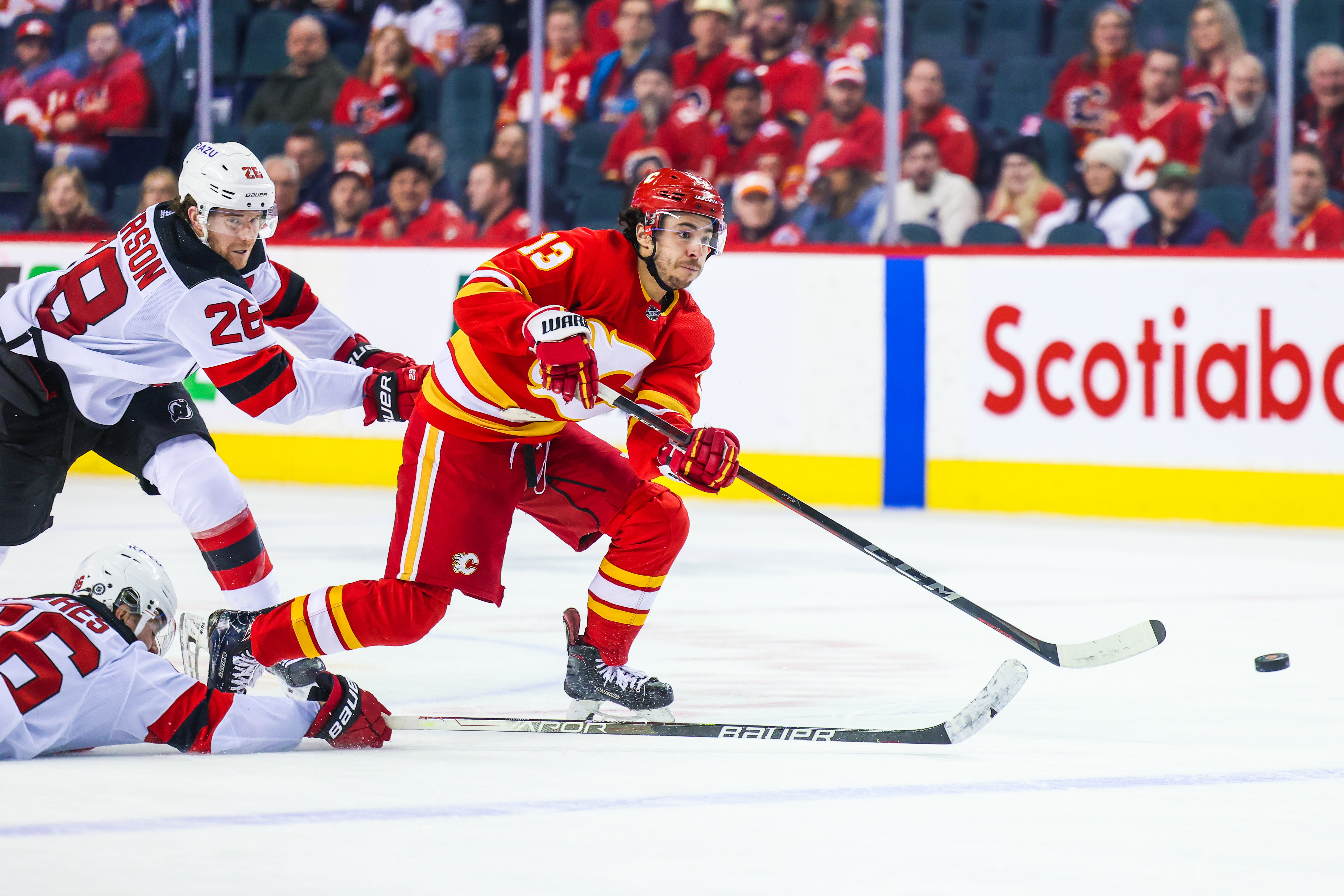 Mar 16, 2022; Calgary, Alberta, CAN; Calgary Flames left wing Johnny Gaudreau (13) scores a goal against the New Jersey Devils during the third period at Scotiabank Saddledome.
