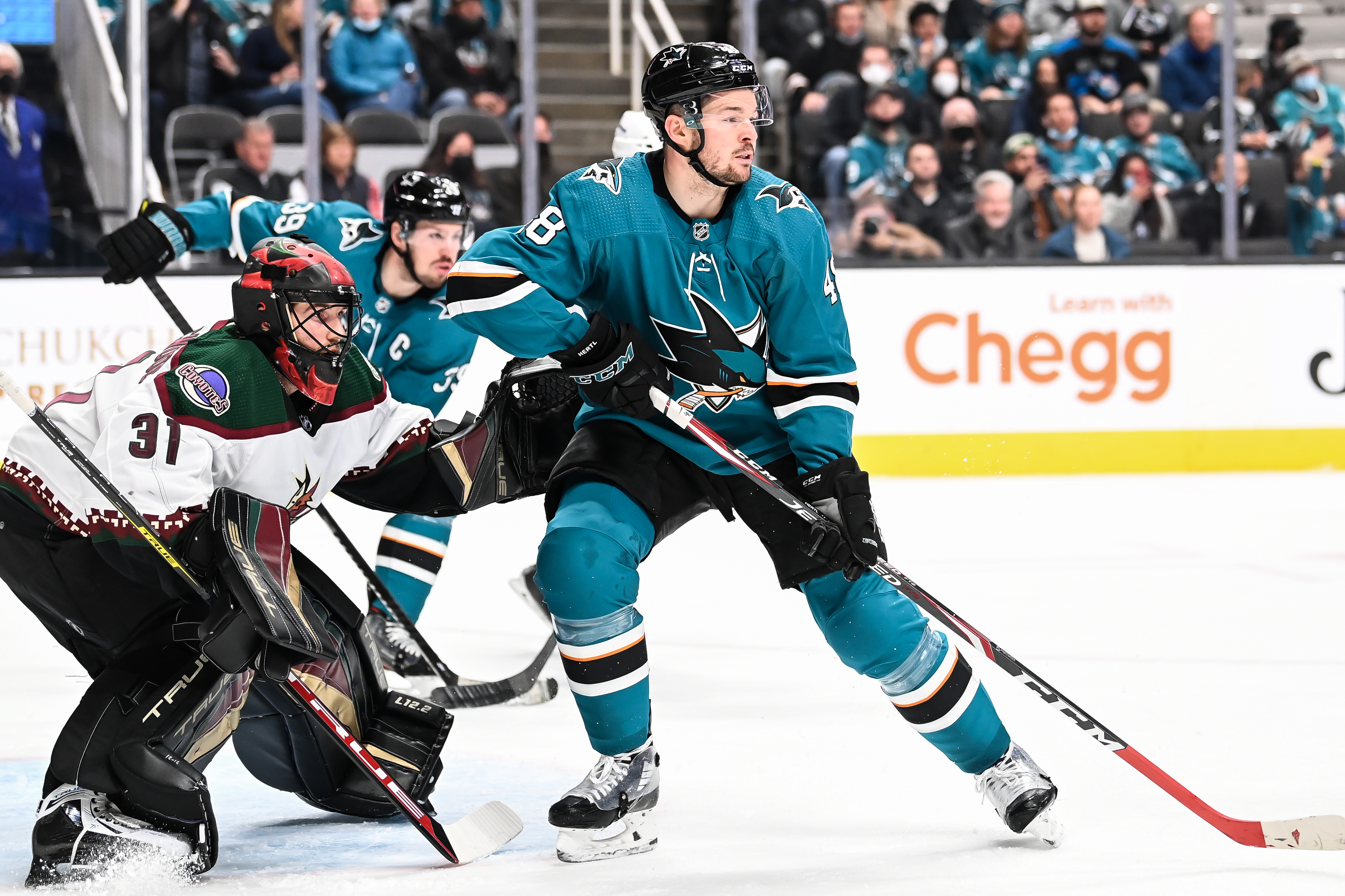 Tomas Hertl #48 of the San Jose Sharks battles in front of the net against Scott Wedgewood #31 of the Arizona Coyotes in a regular season game at SAP Center on December 28, 2021 in San Jose, California.