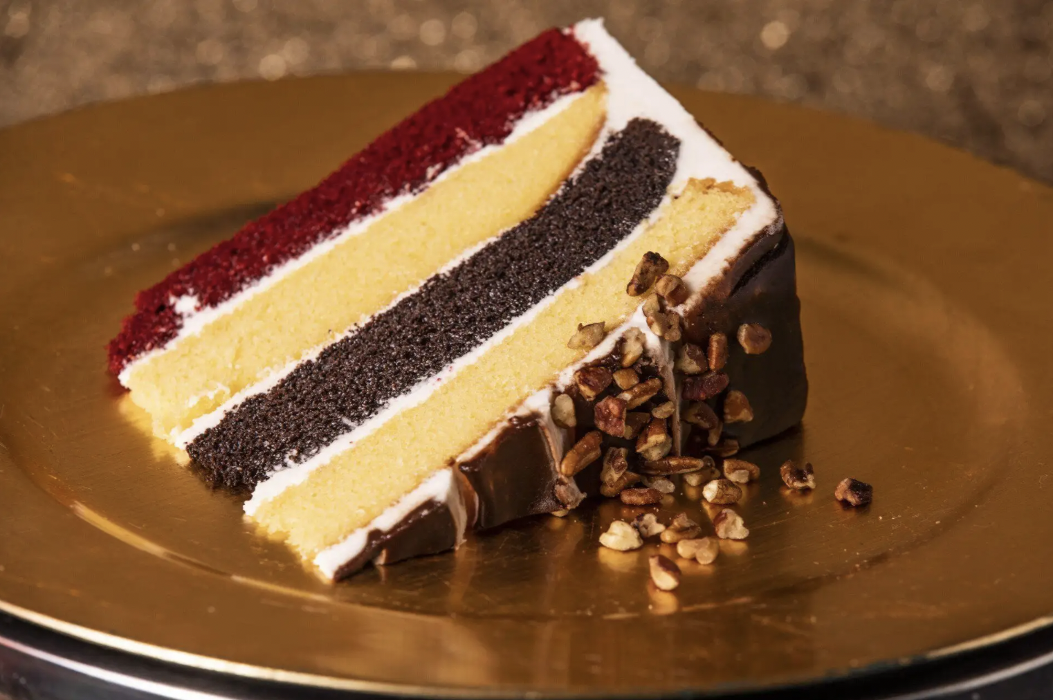 A slice of cake lays on its side on a plate.
