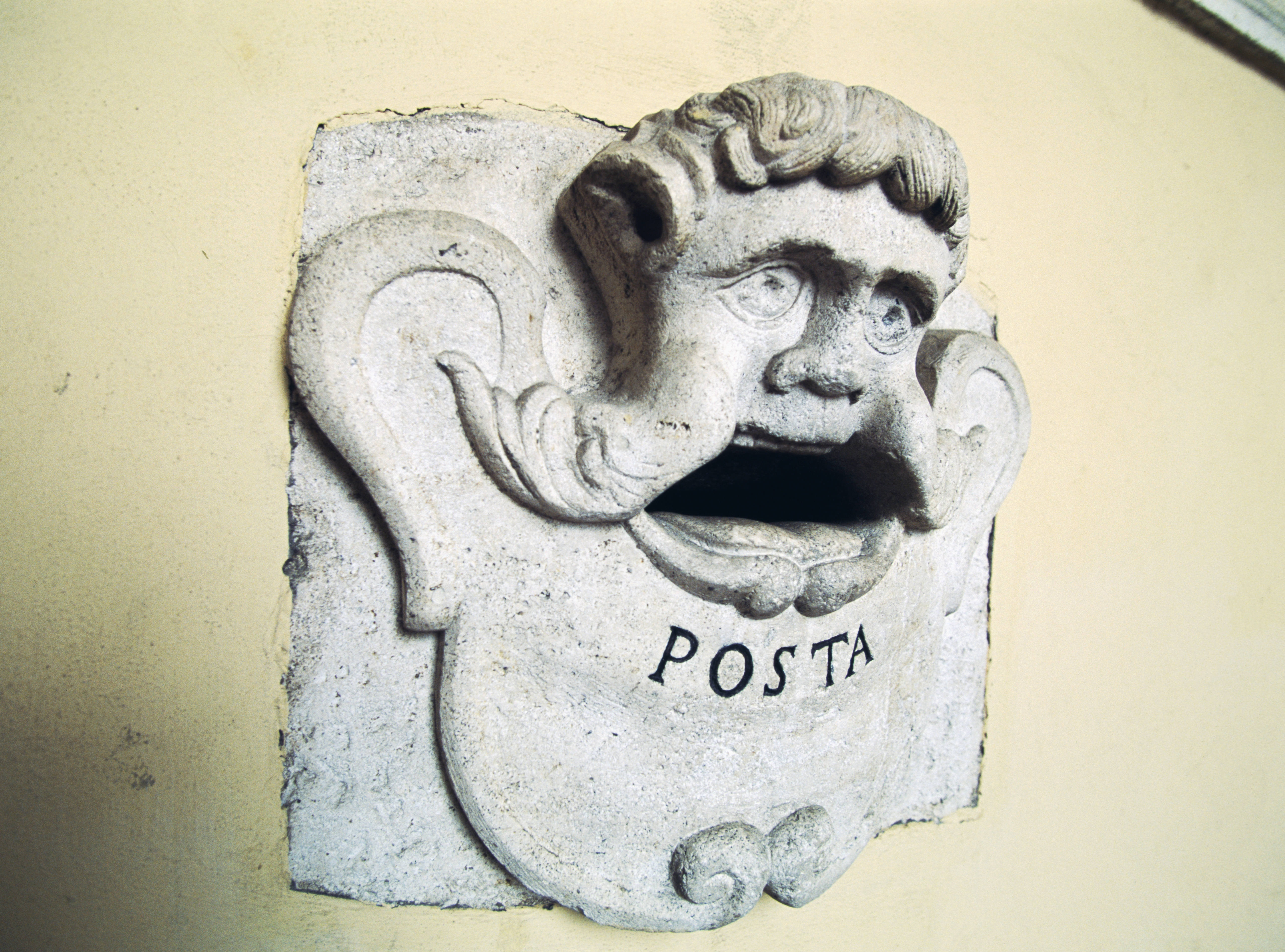 Stone postbox with male figure, Treia, Marche, Italy...