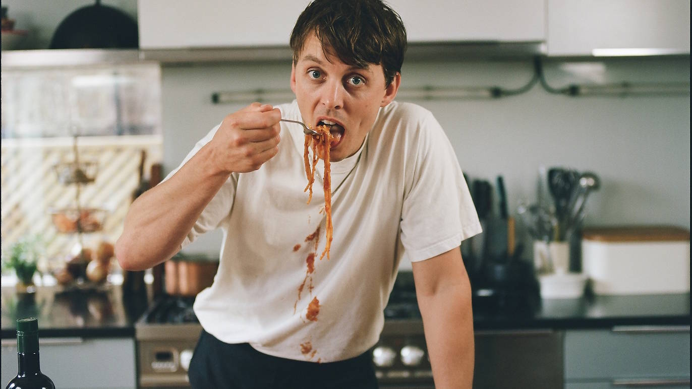Chef Thomas Straker eating spaghetti.